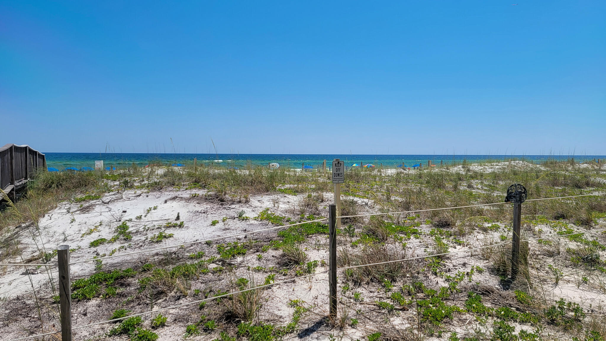 INVEST OR LIVE at this conveniently located FIRST FLOOR unit at the recently remodeled Surf Dweller on Okaloosa Island! HOA DUES REDUCED 1/1/25. Features at this well-maintained large 2 bd/2 ba condo include a huge patio for entertaining, LARGE OPEN KITCHEN with ample cabinet space, granite counters, breakfast bar; private GULF FRONT MASTER SUITE with patio walkout, and a spacious guest bedroom that could sleep 4 comfortably. New LVP flooring in the bedrooms!! Condo has neutral paint colors throughout. Additional features include a nice size pantry & laundry room (W/D included!), and large patio just steps from the beach walkover! Surf Dweller has lush, landscaped grounds, swimming pool with sundeck, kiddie pool, BBQ grills, tennis courts, covered parking, and private walkover to beach.