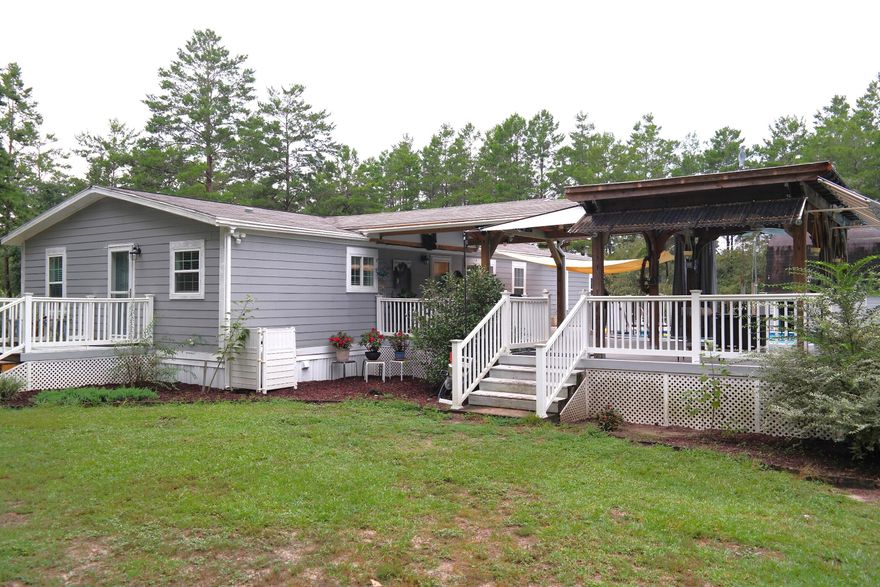 Beautifully renovated triple-wide mfd, home on over 4 fenced ac, off Rock Hill Rd...S of I-10, between Defuniak Spgs. & Freeport & w/in apx. 30 min. to both the beaches of S Walton & Panama City Beach. 1932 SF, 4BR, 2 bath, + office. Int. features include quartz countertops in kitchen, solid surface in baths. Luxury vinyl plank flooring throughout, w/ carpet in BRs. New Shingle roof 2021, Step out the back door to the large, partially covered back deck & above ground pool. There is a detached 24x24 carport; 16x20 shop, w/ stairs to spacious loft storage area; Addtl. storage bldg. w/ attached utility storage. Hardi-plank siding on ext. of home. This is an amazing property & home you'll definitely want to put on your must see list! Home not originally placed on lot, limiting finance options