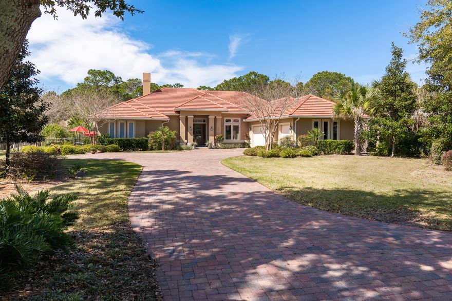 A must-see in Regatta Bay! Impressive curb appeal as home is perfectly situated on an imposing lakefront, professionally landscaped, lot that showcases a newer built custom-designed Florida Coastal home with a contemporary flair. An exceptional setting plus a rare find, one-level living, spacious open floor plan with five bedrooms and 4.5 bathrooms, this home delights. Upon entering, the 14' ceiling announces the large volume of space evident from the foyer and main living areas. A stunning great room is highlighted by an impressive stacked stone gas fireplace, with custom bookcases and entertainment center. Large glass sliders disappear to the screened Lanai, displaying the fully equipped summer kitchen which includes gas grill, stainless steel sink, beverage fridge and granite counter top. Amazing views of the lake abound-enjoy fishing from the private dock. Off the great room, a breakfast area with unique ceiling feature flows to kitchen. The designer kitchen has an abundance of pantry space. Kitchen is equipped with GE Signature stainless steel appliances to include refrigerator, electric oven, warming drawer, a 5-burner gas stove top, and double stainless steel sink - a large breakfast bar with stools, all graced with granite counter tops. A center island comes equipped with a veggie sink, plus granite-topped wet bar also has a sink, built in wine racks, Kitchen Aid Ice Maker and wine fridge, makes entertaining a breeze. Flow into the pleasant dining room for all those special dinners. Light fixtures throughout the main living areas set the mood with a sophisticated touch. Crown molding and tray-lighted ceilings add a classical feel. Efficient Study (or 5th bedroom) has two closets, an en suite bath, custom built-in entertainment center, and bookcases. Study conveniently opens to the lanai via sliding glass door. Master bedroom, with 12 ft. ceilings, overlooks the pool and enjoys its soothing water feature. Spa master bath is truly exceptional with his/her vanities, a large attractively tiled walk-in shower with french drain, a relaxing air jet soaking tub, plus an exercise room and large his/her closets complete this oasis. A large gallery hallway, with 10 ft. ceilings, introduces a delightful queen size guest bedroom en suite, a charming bunk room, a hallway guest bathroom with double vanities, and another twin-bed guest bedroom. All baths are adorned with unique tiles and granite counters. A bright laundry room and handy mud room lead out to a large 3 car garage, with one bay reserved for the golf cart. Pull down stairs lead to the partially floored attic. Other features include beautiful engineered hardwood flooring in main living areas and study, exceptional tile flooring, and carpeted bedrooms. Audio speakers in ceilings provide music throughout. Not only will the pool area and lake entertain, but a large rear lawn faces the nature preserve that is deeded partially to this property. The front of the home also views a pretty lake across the street!

Regatta Bay Golf and Yacht Club offers a serene upscale neighborhood along the Emerald Coast that is enjoyed by all ages. All owners and guests have privileges to tennis courts, pickle ball courts, a large Olympic size pool, kiddie park and pool, plus walking trails and nature preserves abound. The golf course is rated among the tops in the state and membership is not mandatory to be a resident. The Gulf of Mexico is only a golf cart ride south a few blocks. Buyer is to verify all important data. X Flood Plan, Cobra Zone.