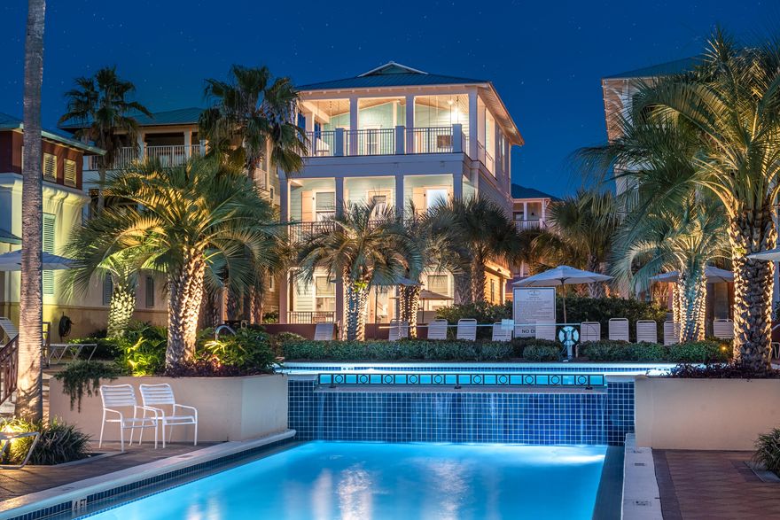 Perfectly-positioned beach home in one of the most desirable locations in Seacrest Beach right on the 12,000 square feet resort-style lagoon pool with abundant lounging areas, a full-service cafe, and expansive green spaces. In total there are 5 bedrooms and 5 full bathrooms PLUS over 1,300 square feet of covered porch space including a massive deck at the very top with picturesque scenery over the beautiful pool area, perfect for relaxing with loved ones after a long day on the beach. When you enter through the front door you'll feel immediately uplifted with it's light and bright colors, plentiful natural sunlight, and beautiful warm hardwood floors. There's a bedroom on your left, laundry room on your right, and the hallway flows into...