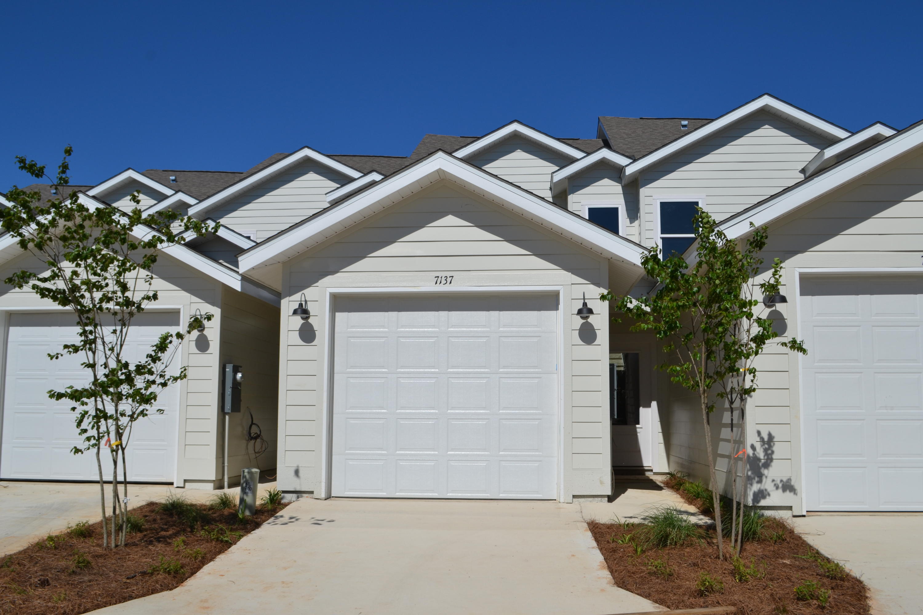 ACCEPTING BACKUP OFFERS. Step into a beautiful, two story 3 bedroom, 2.5 bath townhome with attached garage. The interior offers 9' ceilings, plush carpet in bedrooms, waterproof luxury vinyl plank flooring downstairs and in bathrooms, and granite counters throughout. The kitchen features white cabinets, stainless appliances, and island. The master bedroom is on the first floor and lets on to a lovely patio to expand the living area. The master bath features a large, beautiful tile shower and a walk-in closet. Both full bathrooms offer double vanities and the powder room is located off of the living area. There is recessed lighting throughout, a laundry area, and ample closet space. Ownership includes access to the