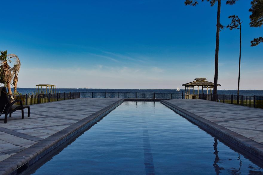 Finest views in Niceville! 

Sitting on nearly an acre of beautifully landscaped property in the exclusive Dana Pointe subdivision, this single-story home is a dazzling combination of elegance and comfort. Enter the front door and feel the expansiveness of the open floor plan and soaring ceilings. The bank of windows on the back provides unobstructed views of the bay and the heated, 25-meter lap pool. In the kitchen, you will find custom cherry cabinets and quartz countertops. The double oven and induction cooktop are new, but if you love a gas range, the connection is there. Check out the vintage Italian chandelier in the formal dining room and the wall-to-wall built-in cherry bookshelves in the library. The living room is huge, wired for surround sound, and has a gas fireplace. The tiled sunroom, currently used as a home gym, is versatile enough for multiple functions. The bedrooms are large, and the primary suite, with a second fireplace, provides a haven of peace and quiet. New maple cabinets and granite countertops adorn the master bath, as well as the laundry room and one of the guest baths. All the closets in the house have been renovated by Artisan-Bilt of Valparaiso. Like to entertain? There are two bars, one in the sunroom, and the other on the screened-in lanai. The pool deck and gazebo provide plenty of space for parties. Enjoy the abundant wildlife, including dolphin, pelicans, osprey and cranes. 

Other recent upgrades include a Generac whole house generator and a Culligan whole house water filter and softener. There are two HVAC systems, installed in 2014 and 2022, respectively. The pool was resurfaced in 2022 with PebbleTec, good for 15 to 20 years. A new irrigation system was installed in 2022, and the house was completely replumbed with PEX piping in 2016. 

This is waterfront living at its best. Come see for yourself.