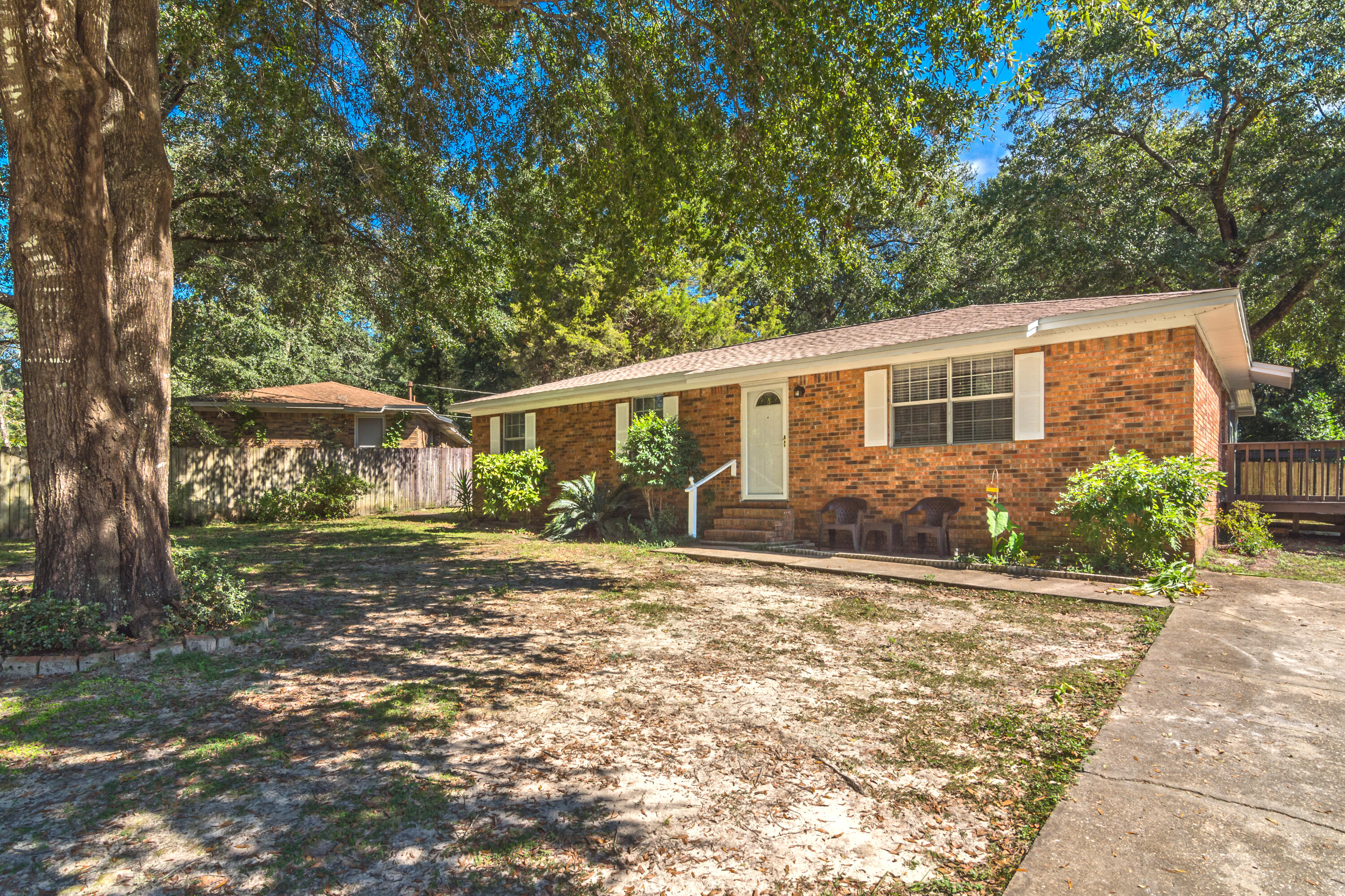 WELCOME HOME! This adorable, centrally-located, home is ready for new owners! Walking in to your new home you will see that there is no carpet in the home which is great for kids and pets. Laminate flooring, and tile in the wet areas, all throughout. New dimensional shingle roof installed in 2019, and new a/c heat pump in 2018. The home features a cozy screened-in porch right off of the backdoor, and almost a half acre lot! There is a huge workshop that is wired for power.. it just needs to be hooked up! There's also an additional shed AND a carport. This home would be perfect for anyone who loves the outdoors and has 4-wheelers, a boat, RV, etc! With plenty of room for your family, and pets, this is one that you don't want to pass up!