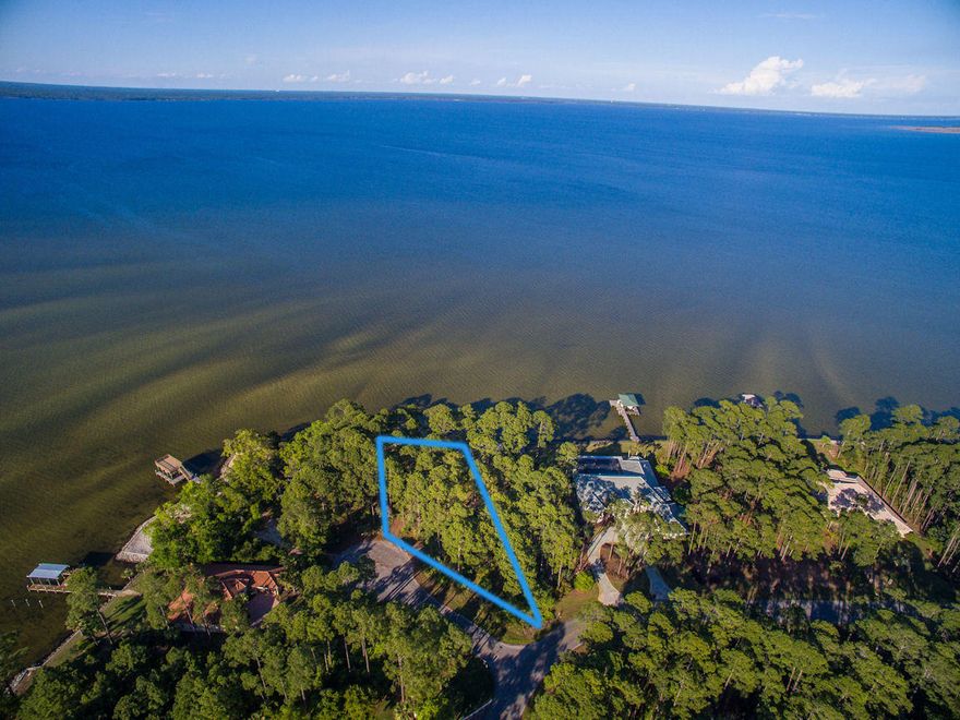 Large Bay-front vacant lot in Driftwood Estates (.662 acres) with a brand new seawall constructed in April 2015 offering 117 feet of pristine water frontage on Choctawhatchee Bay at the northeastern apex of Driftwood Point Road! Sunrises, sunsets, fishing, crabbing, boating, boarding, wildlife viewing, towering oak trees simply a gorgeous setting for waterfront residence! Build your dream Florida coastal residence with the comfort of no build-out time restriction or strict architectural guidelines. Driftwood Estates community is located near shopping, restaurants and bars, theater, various businesses, schools, hospital, and a short drive to the beautiful emerald green shores of Santa Rosa Beach!