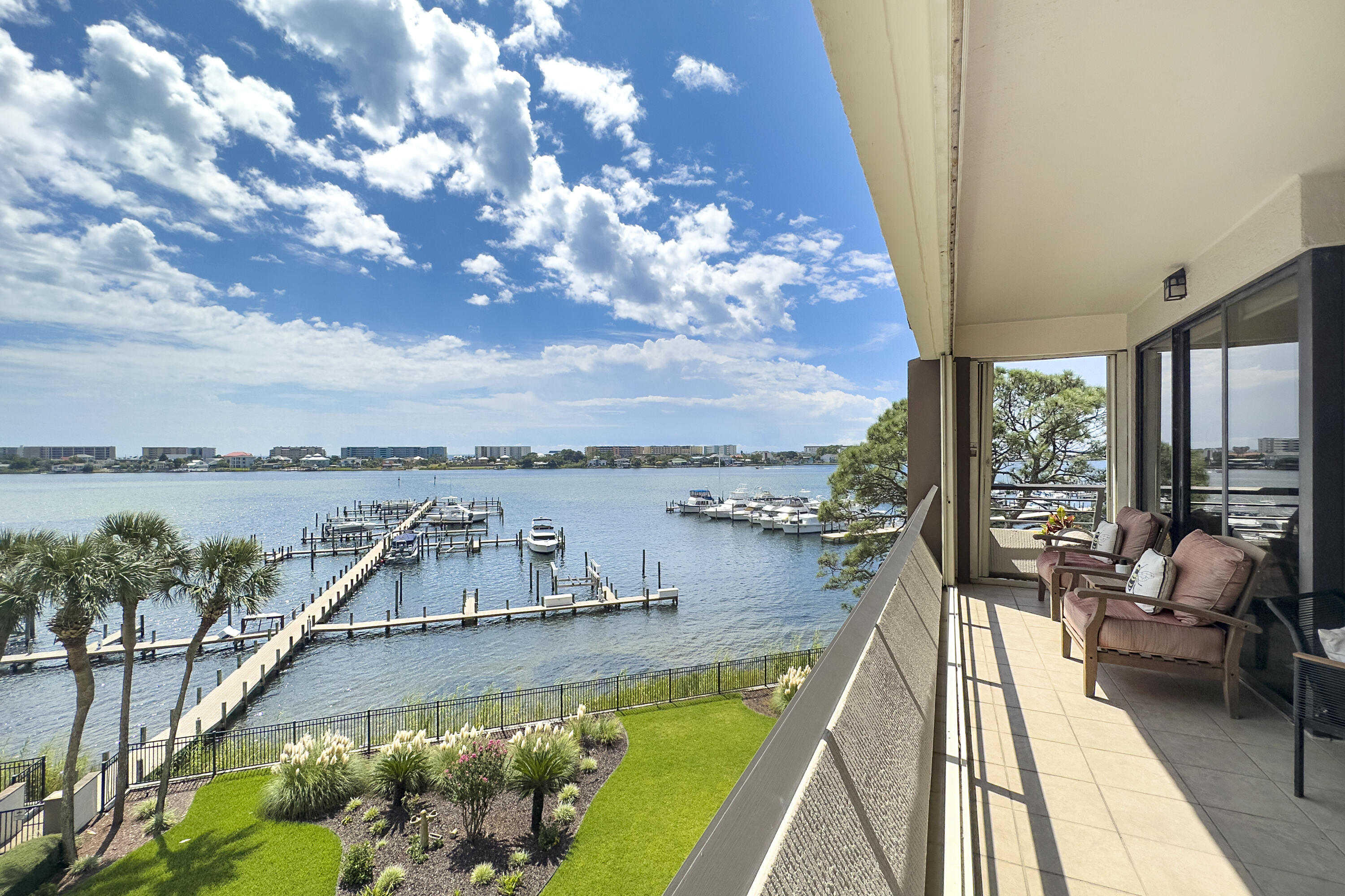 This fully remodeled waterfront unit at 200 West is an extraordinary coastal showplace. This west corner unit sits on the Intracoastal Waterway and offers Gulf of Mexico views in the distance. Features: open and flowing main living areas, two spacious master suites, an additional guest room and bath, a balcony overlooking the pool, marina, and waterfront. This unit makes a great second home or primary residence. Design elements include luxury vinyl plank flooring throughout, quartz countertops, stainless steel appliances, champagne gold fixtures in the kitchen, plantation shutters, and more. This home has been meticulously maintained and includes a new HVAC unit, assigned covered parking, and boat slip (22 ft X 55 ft). This amazing unit is serene coastal living at its very best!
