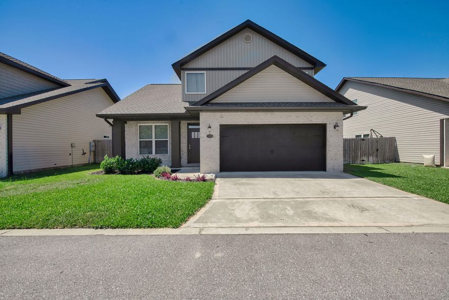 ASSUMABLE VA LOAN AT 5.125%! Step into style and comfort in this beautiful craftsman-style home built by Robbins Builders in 2022. Located in East Navarre, just a short drive to Hurlburt Field, this home blends quality finishes with a smart layout. You're welcomed by a bright foyer that opens to a spacious, open floor plan filled with natural light. The kitchen features white shaker cabinets with crown molding, granite counters, an undermount sink, stainless steel appliances, and a breakfast bar--perfect for everyday meals or entertaining. Bullnose corners and recessed lighting add a clean, modern feel throughout. Downstairs includes a flexible room currently used as an office, plus a convenient half bathroom. Upstairs, the master suite offers a large walk-in closet, double sinks with granite counters, and a tiled walk-in shower. Two additional bedrooms and a full guest bath complete the second floor. Luxury vinyl plank flooring runs throughout the home, offering both style and durability. Outside, enjoy a fenced-in yard ready for pets, kids, or relaxing evenings. The home also includes hurricane protection for windows. Built with care and filled with upgrades, this home is move-in ready and close to everything Navarre has to offer.