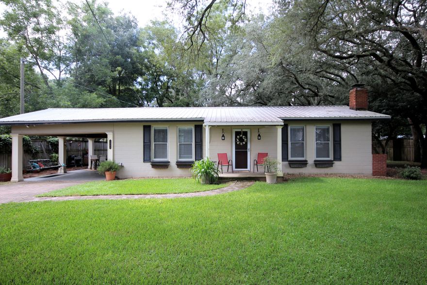 Pending with back up contract! Wide open spaces with no HOA on 1/2 acre close to town & the world's most beautiful beaches. This adorable 2 bedroom, 1 bath Florida cottage is full of charm and character. Follow the paver driveway and walkway to your front door and enter to authentic pine hardwood floors, shiplap ceilings, painted built in bookshelves and cozy fireplace. Kitchen has been updated with beautiful Hickory custom cabinets with wine rack, deep single bowl sink, breakfast bar and plumbed for gas range. Large mud room-laundry room with utility sink and plenty more cabinets. Study nook could be 3rd sleeping area. Exterior is low maintenance concrete block and cypress siding with metal roof and brand new septic tank (2018). New tankless gas water heater (2018).