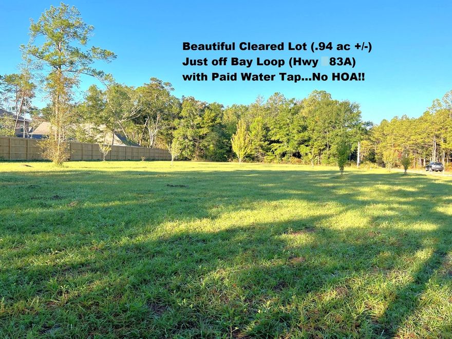 Beautiful cleared lot on just shy of 1 acre (.94 ac +/-) located just outside of town on Power Line Rd (off Bay Loop / Hwy 83A East). Tap fee has been paid and no HOA! This property backs up to Live Oak Harbour and privacy fence runs along the S border of property. Seller has several trees planted (various pear, pecan, birch). This is a beautiful lot and only minutes to Four Mile Creek Landing, Publix and local dining. Also, within 20 minutes to the beaches of S Walton, shopping & fine dining in Destin. Power Line Rd is apx. 3/10 mi to end and County maintains the road to about halfway down. This won't last long, so come see today!