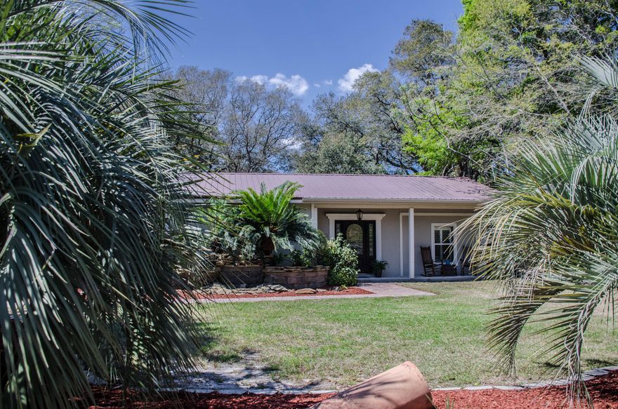 An absolutely charming home with so much character! Home has been completely remodeled to include a kitchen that will be the envy of all your friends. GAS STOVE, BUILT-IN OVEN, large eating bar, GRANITE, TILE AND CUSTOM CABINETS. The great room and dining area is off of the kitchen, while a second living room is located off of the foyer. Split bedroom floor plan, the second bedroom is currently being used as an office.The master bedroom has been recently painted a soft color.You will be in awe at the size of the master bathroom's shower! No need to wait till the water heats up, you have a tankless water heater. There is an additional walk-in closet and full bathroom near the laundry room.The detached 600 sf GUEST HOUSE is complete with kitchen, full size bathroom and spacious bedroo