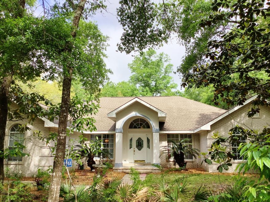 Price REDUCED! Homes in Shirks Bayou rarely come on the market. Known for its tranquil, tree lined streets, large lots & executive style homes, this all brick beauty sits nestled on .83 acres, surrounded by magnolias, hickory's, oaks & various palms. You'll feel tucked away, yet convenient to everything! One owner, custom built with 12' ceilings, formal Living and Dining, PLUS Great Room with kitchen, featuring cherry cabinets w/pull out drawers, breakfast bar, & custom pantry. Huge FL room opens from LR, Great Rm & Master BR, which features huge walk in closet, sitting area, and Mstr bath with dbl vanities, whirlpool tub & shower. 2 add'l bdr's have tray cielings. The 4th bdr is an office/Bdr combo. 16x32 screened inground pool has a full pool bath, plus so much more...