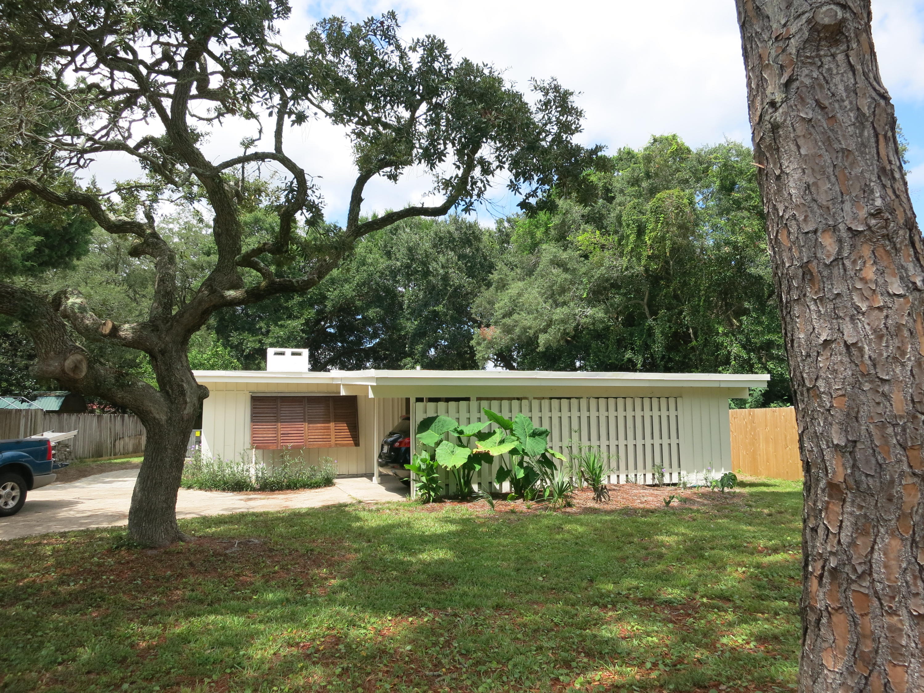 Charmingly unique and completely restored to its original character.-Decorative paver sidewalk to front entry(left side of home)-New roof 2016-New HVAC unit 2016-New carpeting in all bedrooms-New refrigerator, dishwasher & stove-New HWH 2016-Stackable W/D-New countertops-New light fixtures-Copper Wiring-Oversize carport.-Large covered breezway for outside entertaining/seating 14x21-New ceiling fans in all bedrooms-Painted inside and out 2016Exposed wooden beamed ceiling in ALL rooms and charming vintage windows in dining/kitchen. Window treatment included in kitchen/dining.Skylights in both bathrooms.Large open kitchen/dining area totally upgraded including ceramic tile flooring in all common areas. Large breakfast bar.-Woodburning fire place