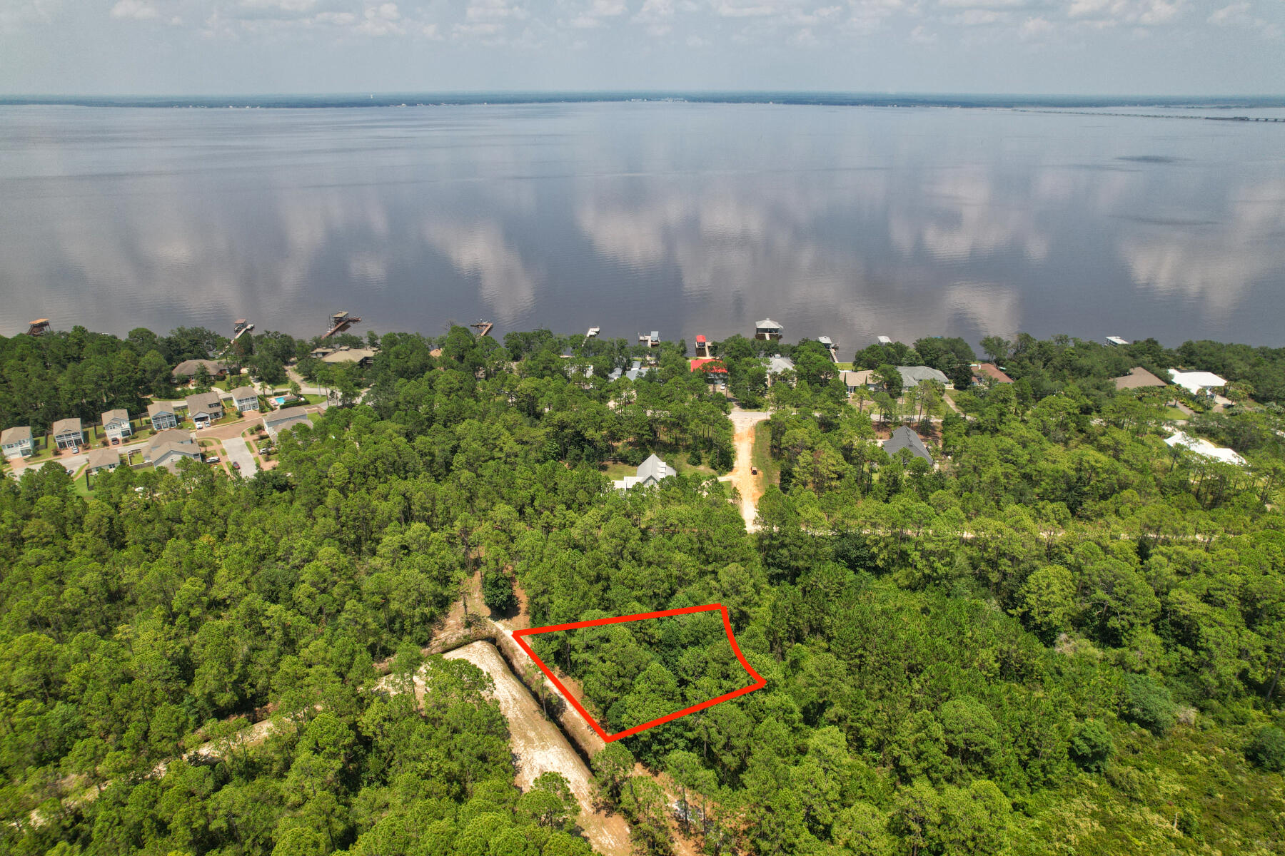 An excellent opportunity to own your piece of paradise in Santa Rosa Beach! This lot is ideally situated in a quiet enclave approx. 500 feet from the Choctawhatchee Bay. The property was partially cleared in December 2021. A recent wetlands study reveals no wetlands, a new boundary survey is available. This lot is not governed by any Homeowner's Association so there are no dues or Architectural Guidelines and very simple covenants and restrictions. The location is ideal and is a short distance to Cessna Landing Park which offers a fishing pier, boat launch, and a straight shot down 393 to several Public Beach Access along 30-A. Also, and shopping at Grand Blvd and medical facilities like Sacred Heart Hospital and several area Restaurants. Discover your forever homesite