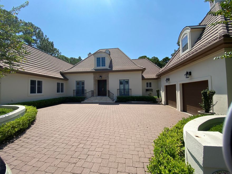 Country French inspired home is nestled on an estate size lot in a private cul de sac in the exclusive Burnt Pine neighborhood within Sandestin.