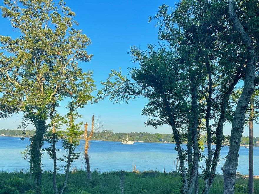 Enter into one of the most beautiful townhome in the community. Renovated to perfection and ready for a new owner to enjoy.Pictures speak a 1000 words and no expense spared here. Expanded deck, large kitchen area fully equipped with gas stove , tons of cabinets, drawers and counter space.  Kitchen opens to a family sitting room with beautiful views of the bay. Smooth ceilings with recessed lighting throughout. Third bedroom on lower level with full bath. Each bdrm. has it own bathroom. Unique to other townhomes is the outside storage with walk in crawl space for all your water toys. All windows have been replaced including a storm door on front porch. Extra long driveway for your guests.You will not be disappointed and thrill to have this beautiful home to enjoy your piece of Paradise