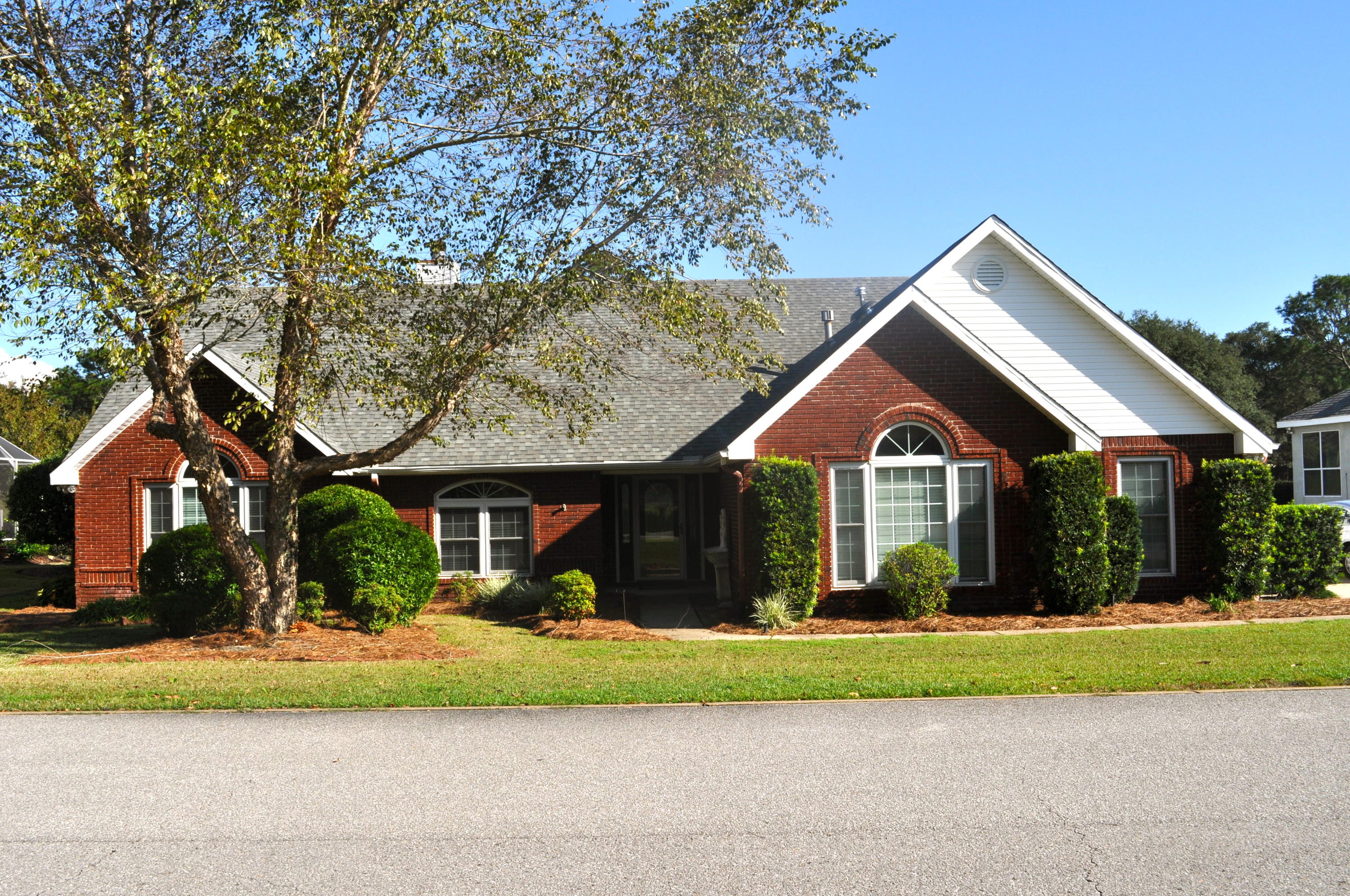 LOCATION! Beautiful brick home situated perfectly on #15 at Shalimar Pointe. Enjoy this spacious and split-bedroom floor plan. Interior features include: vaulted and raised ceilings throughout, granite countertops, tile and hardwood flooring through main living areas, 4 bedrooms in addition to an office. Exterior features include: lush landscaping, screened porch, and expansive views of #15 at Shalimar Pointe. Make 915 The Masters Boulevard your Shalimar home today!