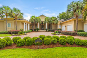 Updated- Elegant design elements flow throughout this stately resort home. Located in the coveted streets of Ravenwood. You will enter through beautiful glass inlaid double doors into a dramatic foyer, with vaulted ceilings and gaze directly out to a totally private enclosed sparkling pool, spa, outdoor kitchen,landscaped yard and lake enhanced with gracious royal palms. Beyond the privacy hedge is the 11 fairway of the exclusive Burnt Pine golf course. Highlights include five spacious bedrooms, all with en-suite baths, an inspired first floor master wing with en-suite bath w/ fireplace, spacious closet /dressing room upgrade, and a kitchen/family room complex with convenient bar, and separate carriage house for guest.