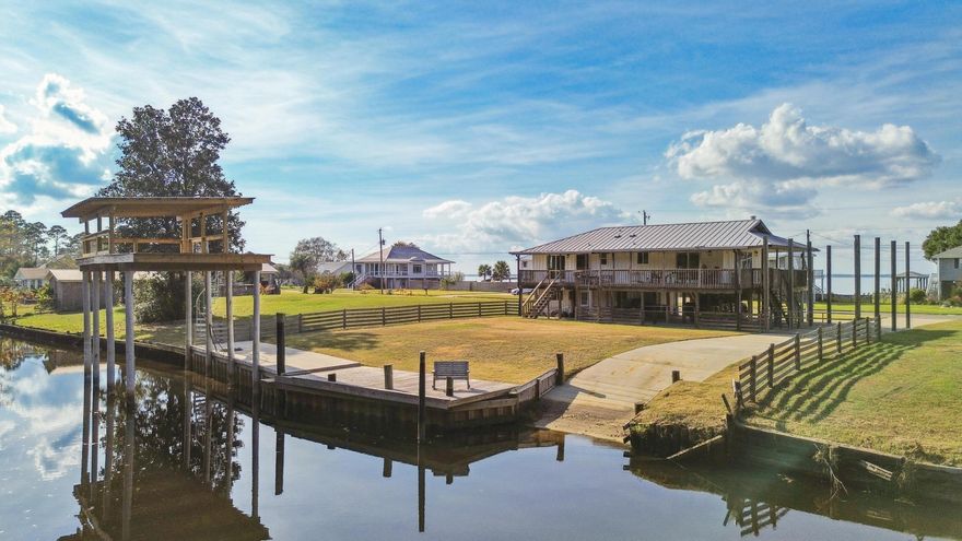 Welcome to a rare waterfront retreat offering the perfect blend of coastal charm and modern updates.

Nestled on a quiet canal with direct bay access to the Gulf, this property is a boater's paradise. Featuring a private paved boat launch and brand-new dock with boat slip, it's designed for effortless days on the water. The slip accommodates vessels up to 40 feet, and with canal depths ranging from 6-8 feet, you'll enjoy smooth navigation for fishing trips, sunset cruises, or adventures out to the Gulf.

Step onto the covered wraparound porch, where serene bay views greet you from the front, and breezy afternoons overlooking the canal await on the side and back. Whether you're sipping morning coffee or watching boats glide by, the outdoor living spaces are made for relaxation and entertaining.

Inside, the home has been thoughtfully refreshed with updated paint, vinyl flooring throughout, and a modernized kitchen and bathrooms. The kitchen features a gas stove and stylish finishes, while the bathrooms offer clean, contemporary design. Every detail has been considered to create a move-in ready home that feels both comfortable and inviting.

The exterior has been refreshed for added curb appeal, but it's the waterfront amenities that truly set this property apart. With its prime location, updated interiors, and unbeatable boating access, this isn't just a homeit's the ultimate Florida lifestyle.