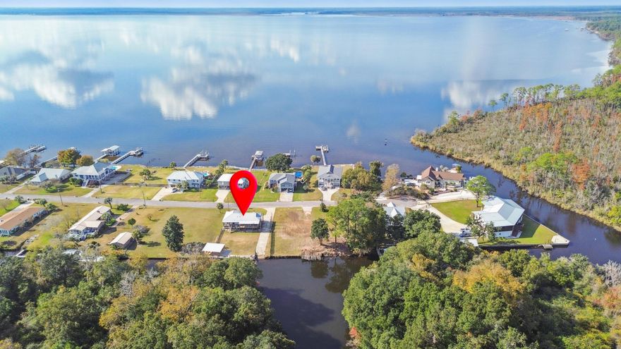 Welcome to a rare waterfront retreat offering the perfect blend of coastal charm and modern updates.

Nestled on a quiet canal with direct bay access to the Gulf, this property is a boater's paradise. Featuring a private paved boat launch and brand-new dock with boat slip, it's designed for effortless days on the water. The slip accommodates vessels up to 40 feet, and with canal depths ranging from 6-8 feet, you'll enjoy smooth navigation for fishing trips, sunset cruises, or adventures out to the Gulf.

Step onto the covered wraparound porch, where serene bay views greet you from the front, and breezy afternoons overlooking the canal await on the side and back. Whether you're sipping morning coffee or watching boats glide by, the outdoor living spaces are made for relaxation and entertaining.

Inside, the home has been thoughtfully refreshed with updated paint, vinyl flooring throughout, and a modernized kitchen and bathrooms. The kitchen features a gas stove and stylish finishes, while the bathrooms offer clean, contemporary design. Every detail has been considered to create a move-in ready home that feels both comfortable and inviting.

The exterior has been refreshed for added curb appeal, but it's the waterfront amenities that truly set this property apart. With its prime location, updated interiors, and unbeatable boating access, this isn't just a homeit's the ultimate Florida lifestyle.