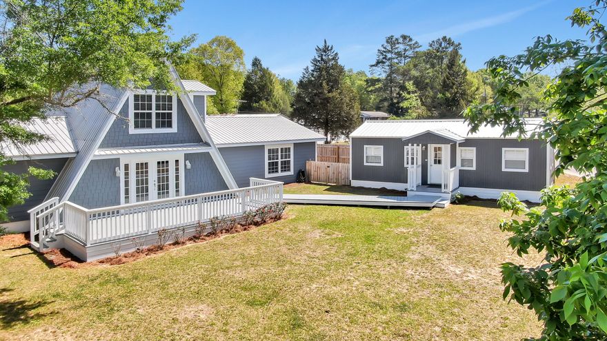 With a Cape Cod feel, nearly 3000sf with lake views, 5 beds/3 full baths PLUS a separate 600sf home office building (or teenage hangout?!). Only 800 original sq ft - the remainder was constructed in 2015 & all was renovated perfectly on trend w/ the latest materials & design. Custom everything, including reclaimed wood columns & shelves from an old beach house. Amazing kitchen w/ island & expansive granite counters & cabinets & touch-activated faucet. Downstairs is a sizable master suite w/ slipper soaking tub, 4x5 custom tiled shower complete with body sprays & his/hers closets & custom built-ins. Two more beds/1 bath down - with 2 beds/1 bath up. This home is light and bright & made for a family! Fenced yard & boat launch down the street too. Home is 2916sf and home office is 512sf.