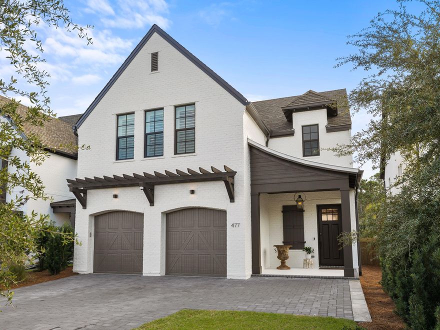 Located in the brand-new upscale community of RidgeWalk, this outstanding home has a plethora of custom upgrades to the original plans including an elevator, additional closets and a bonus office. Custom window treatments, Roman blinds, accent walls and plantation shutters are just part of the high-end finishes rarely found in newer homes. This characterful home is fronted by a full-width brick paver driveway for multiple vehicles and craftsman-style doors to the two-car garage. A covered porch shelters the main entrance door. Mellow wood flooring, an exposed brick fireplace and lap-and-gap accent walls grace the nicely proportioned living area of this quality home. The light open space is enhanced with country farmhouse-style features on the kitchen island, which houses an apron sink and