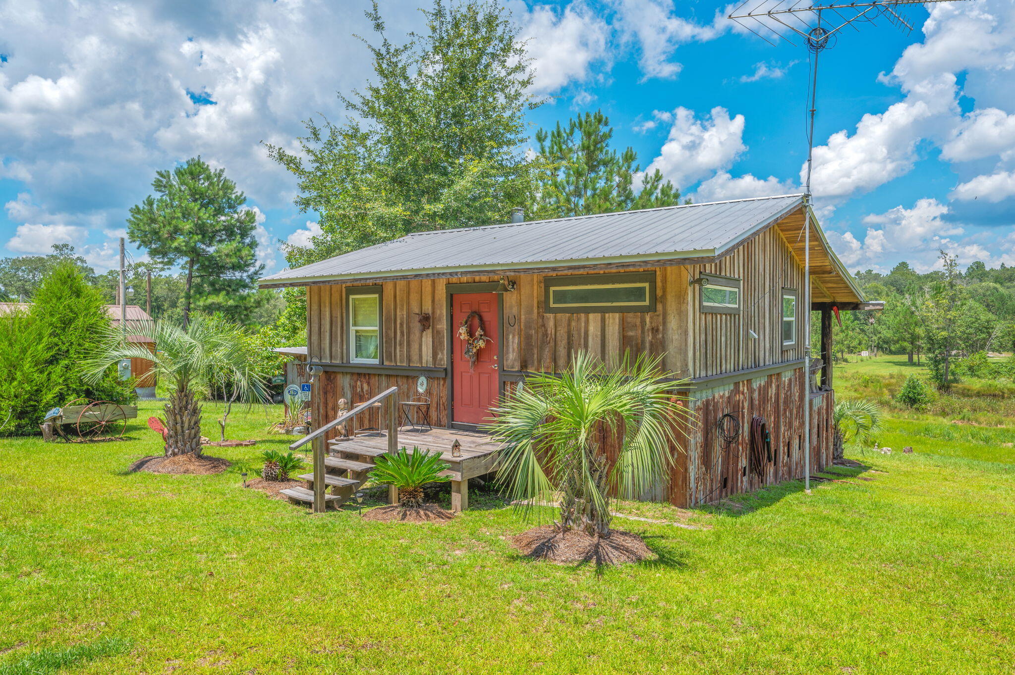 Custom built cabin on 3 waterfront acres on Wing Road just over the Florida line in Escambia County AL. Property features hardwood throughout, energy-efficient double pane windows that provide comfort and natural light, a woodburning stove, custom cabinets and counter tops, as well as tons of extra touches to utilize every ounce of space. Home offers a large kitchen, living room and full bathroom designed to maximize the layout along with an amazing outdoor back covered porch. The property has Black Creek running through it and has a staircase down to the creek as well as a pond to enjoy your own private retreat. This property provides endless outdoor fun, gardening, swimming, floating in creek to the river, or simply enjoying the view of the pond and deer from you back porch. and deer from you back porch. Quality-built cabin was built by a contractor with excellent value, offering quality creek-front living without compromising on craftsmanship! A MUST see!