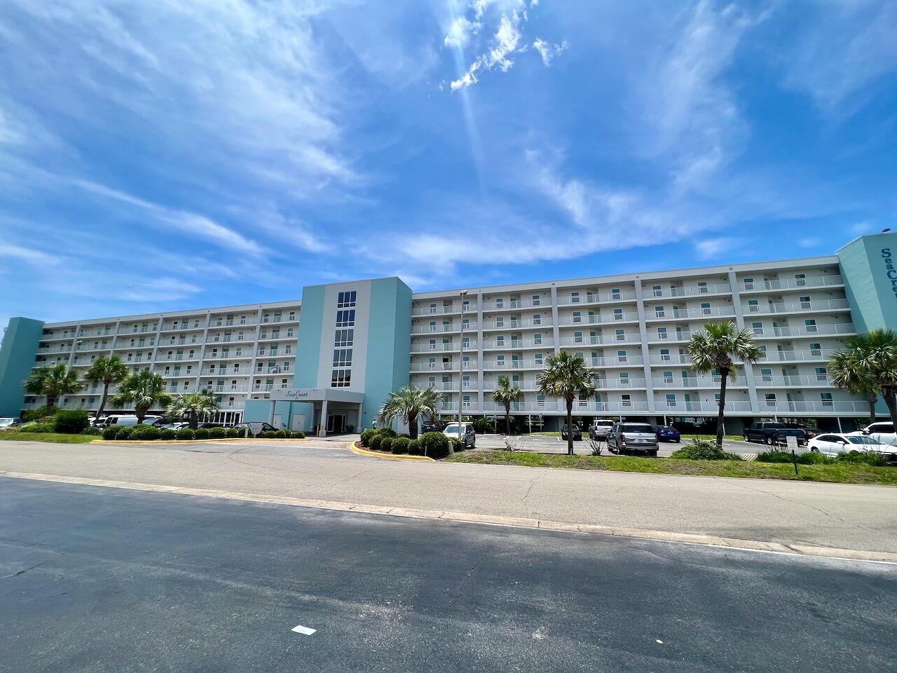 Partially Furnished Condo for Long Term Rent on Okaloosa Island. View of the Gulf of Mexico from primary bedroom and living room. Covered Balcony. Open Floor Plan with Kitchen Bar, Dining Area and Living Room.