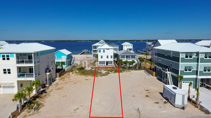 BUILD YOUR DREAM!! Imagine waking up to gulf breezes, stunning sunrises and sunsets, within minutes of public beach access to the sugar white sands and turquoise waves with this premier lot. This is one of Navarre Beach's most desirable addresses. Whether you dream of a stylish coastal home, a vacation rental gem or your forever retreat, this clean canvas gives you that option. Blending outdoor adventure like paddle boarding, kayaking, surfing, boating, jet skiing to enjoying coastal nature with sea turtles, dolphins and pelicans. There's freedom with no HOA, short term rentals allowed and public utilities. Plenty of opportunity for residual income or your primary piece of paradise. Minutes from dining options include Andy D's, Beach House Social Bar & Grill, Juana's and Windjammers. From live music enthusiasts to beach dwellers, the coastal life has so much to offer. Nearby bike/walking paths, Sea Turtle Conservatory, boutiques, golf cart rentals and coffee shops. Start your day with breathtaking sunrises, walks or yoga on the beach, finding the perfect seashells, bike rides through the community to ending the amazing day to a glass of wine, some sweet tea, entertaining friends and family while the sunsets and you take it all in. HWY 98 is a short distance off the bridge to top rated schools, Walmart, Publix, Winn Dixie, hospitals, shops, other dining options and local favorites like Stripes and Tommy's SnoBalls. Builder renderings available and can be customized. Your slice of paradise is waiting, let's build your beach story. 