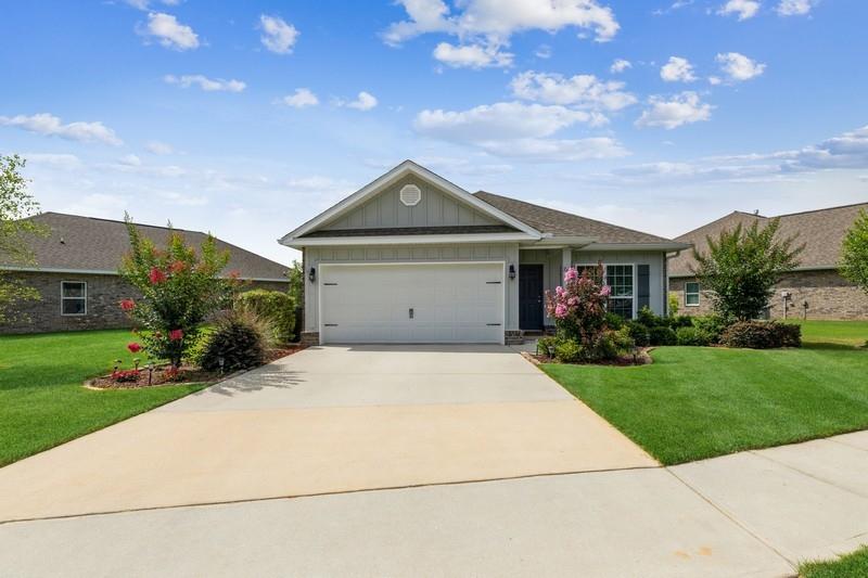 This lovely home located in Passages has been meticulously maintained! This is an Oakley 3 bedroom 2 bathroom floor plan. There are 9' ceilings, tile floors everywhere but the bedrooms, island in the spacious kitchen. The master bathroom was upgraded with a walk in tile shower with a bench. The master bedroom has trey ceilings with crown molding. Enjoy evening on the screened in back porch overlooking the lake. There is also a flex room up front for an office or sitting area. Don't miss the opportunity to call Hammack Bay home, there are so many wonderful amenities in this neighborhood including a pool, clubhouse, fitness center, tennis and basketball courts and a general store.