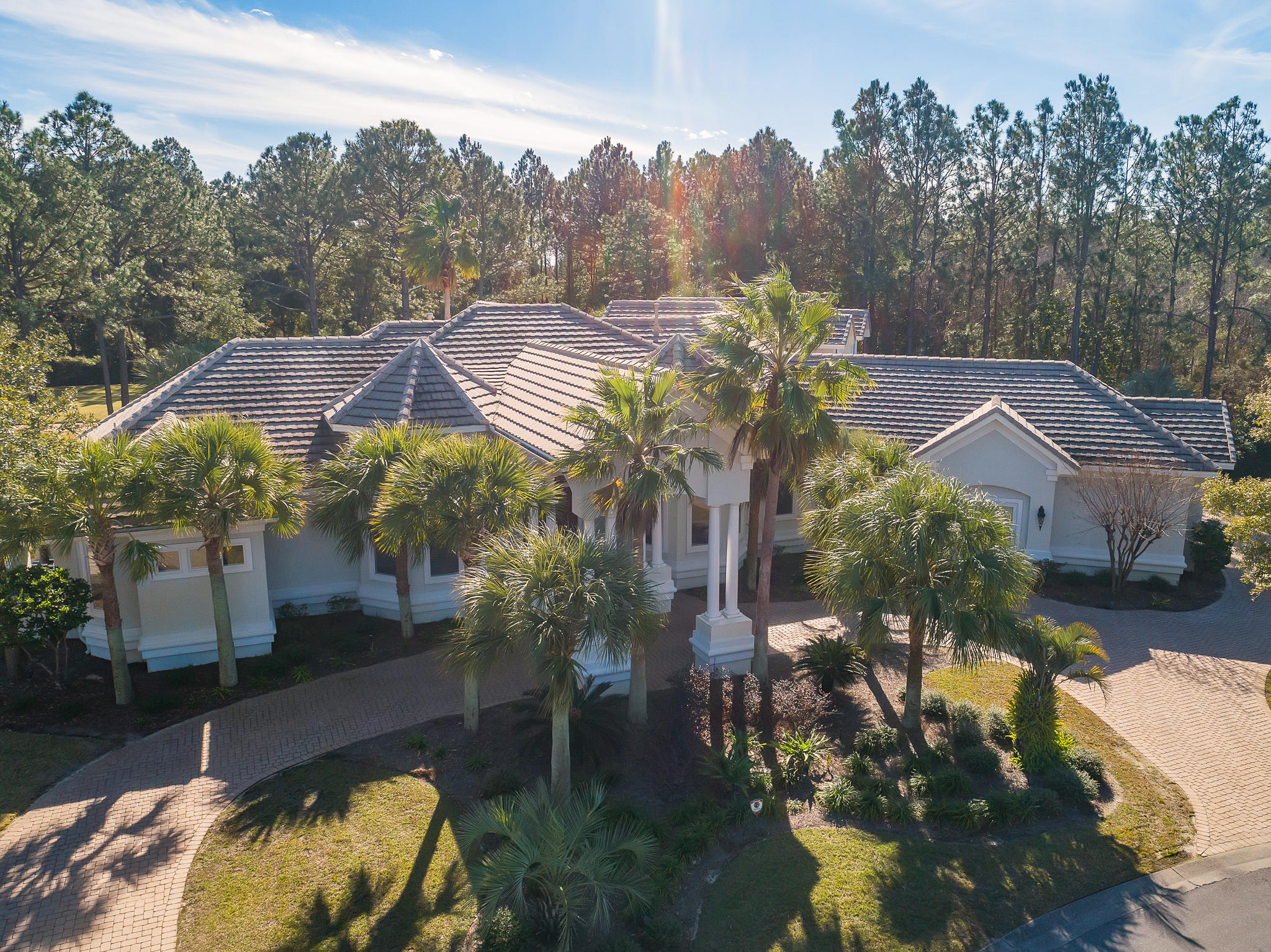 From the grandeur of a palace in the double mahogany front doors, foyer, formal living room and dining room to the casual elegance of the breakfast bar or wine tasting counter, spiral staircase and family room fireplace, this home offers warmth, beauty and an aura of romance. It sits on more than half an acre in a park-like setting of palm and pine trees bordering the 13th hole of the Raven Golf Course. Uncompromising quality is evident in exquisite tile and wood floors, crown molding, surround sound, architecturally interesting ceilings in unexpected places and abundant large windows.