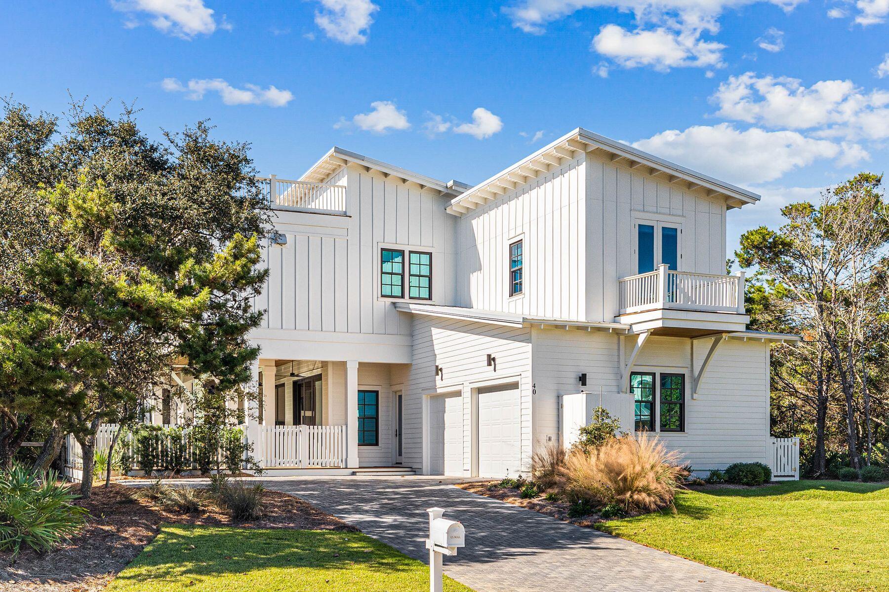 This contemporary coastal retreat is in a prestigious non-rental gated community with beach access. Newly completed by Boswell Builders, this custom beach house offers more than 4,000 square feet of luxury living with two living rooms, six beds, five baths and two half-baths. A long paved driveway provides ample parking and access to the attached two-car garage. Accommodation is spread over two floors, with the main living space and two bedrooms on the second floor, taking advantage of the stunning views. Doors lead out to a spacious covered balcony. It's perfect for alfresco dining, relaxing around the fire pit and enjoying fresh sea breezes and breathtaking views. Climb the spiral staircase to the rooftop deck and look across the treetops to the shimmering Gulf of Mexico from your lounge chair. The open great room and dining area are ideal for entertaining and family gatherings. In the gourmet kitchen, white cabinets complement a beautiful backsplash with glossy herringbone-pattern tiles. Stainless steel appliances include a Wolf range and a Sub-Zero refrigerator. The lengthy island with stools is sure to be a social hub. The primary suite is truly impressive, with a deep coffered ceiling and dual-aspect windows. A private balcony is perfect for sipping a quiet cup of coffee from the drinks station before the day begins. The spacious master bath has a granite-topped twin vanity, a garden tub for bubbly soaks and a separate walk-in shower. Down on the first floor, as well as three guest bedrooms, you'll find a den and an exercise room. The enclosed rear yard is a place to relax in the private pool and spillover spa. It is overlooked by a generous outdoor porch boasting a magnificent kitchen with a built-in grill, sink, refrigerator and hood. A nearby boardwalk provides access to the beach for morning strolls with sandpipers and pelicans, and there's easy access to 98 via WaterSound Parkway.