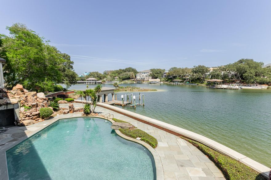 PREMIER WATERFRONT ESTATE -  Experience coastal grandeur at this premier Gulf Breeze waterfront estate, offering 825 feet of pristine shoreline and 2.98 acres of manicured grounds. Spanning 14,203 sq ft, this architectural masterpiece combines timeless luxury design  and expansive living areas open to 6,000+ sq ft of terraces, a resort-style pool ideal for entertaining or sunset dining. Inside, the chef's kitchen, elegant formal rooms, and serene primary suite with sweeping water views reflect the finest craftsmanship. With two deep-water docks for yachts, multiple guest suites, and panoramic bay vistas, this estate is a sanctuary of sophistication and privacy--just minutes from Pensacola's charing downtown or to beautiful Pensacola Beach. Refined waterfront living at its finest.