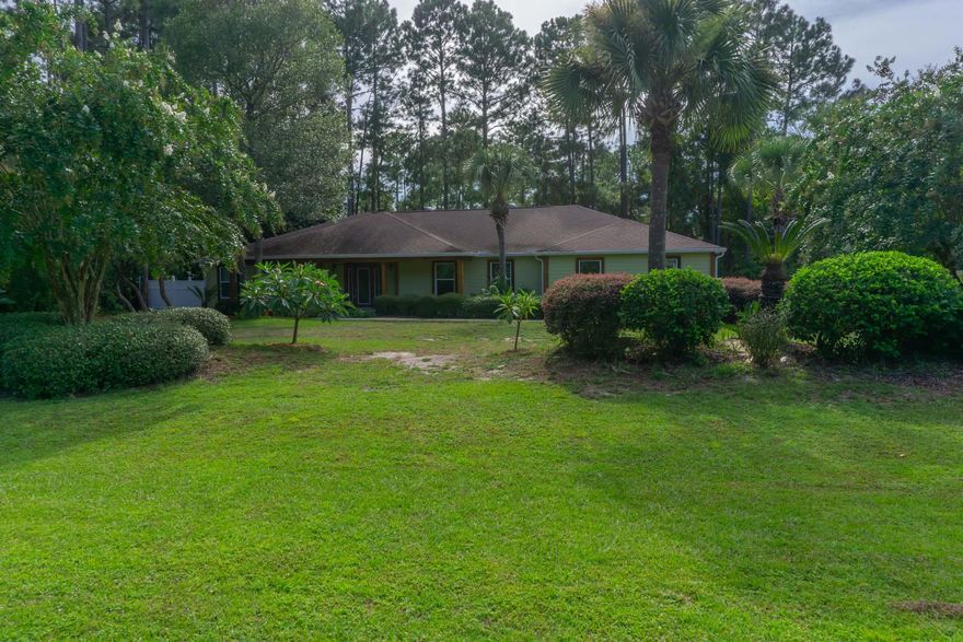 This beautifully renovated home sits on a half acre of land in the heart of Santa Rosa Beach, just a few minutes to 30A and the beautiful white sand beaches of the emerald coast.  Conveniently close to shopping, restaurants and other necessities, this property is fabulous!  Gorgeous domestic hardwood cherry floors run through the bedrooms and the dining area.  The dream kitchen and butler area, complete with granite counter tops and a gas stove, triumph custom Bird Peck Tidewater Red Florida Cypress cabinets and a Caribbean Heart Pine back splash. Oversized tile in the kitchen, living area and bathrooms beckons a family with children and pets.  The outstanding quality of wood improvements include:  the mahogany kitchen bar, Pecky Sinker Cypress mantles, Live Edge Mahogany floating shelves