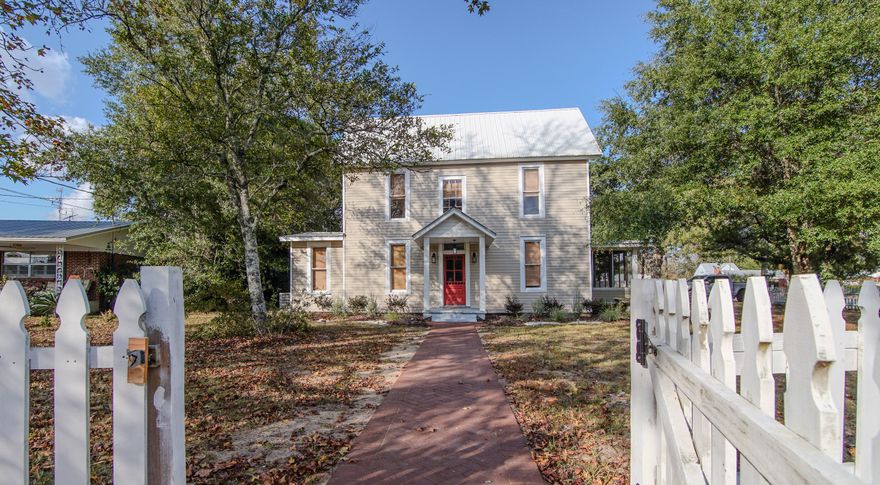 Character in every way, this beautifully maintained home sits on a corner lot just one block from Lake DeFuniak in the historic district. The heart pine floors gleam, complemented by tall windows with original glass, high ceilings, and vintage doors and hardware that preserve its historic charm. The completely renovated kitchen features custom inset cabinetry, quartz and butcher block countertops and a new backsplash. Both bathrooms have been tastefully updated, and the master bath and laundry now include new tile flooring. The master suite is located on the main level, with three additional bedrooms and a full bath upstairs. Two spacious landing areas offer flexibility for an office, playroom, or sitting space. The distinctive split staircase adds architectural interest, and with a new HVAC (2 units) and new water heater, you can enjoy the relief of knowing you have years of systems' life left! The screened porch off the kitchen provides an inviting space for relaxing or entertaining. A new brick walkway enhances the welcoming entry, and a small detached garage and storage building provide additional utility space. The location is exceptional - stepping out the front door to go walk Lake DeFuniak is a true gift! Walk or ride to downtown and enjoy all that small town life has to offer. 