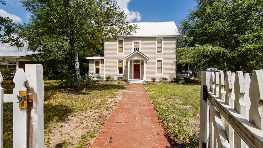 Character in every way, this beautifully maintained home sits on a corner lot just one block from Lake DeFuniak in the historic district. The heart pine floors gleam, complemented by tall windows with original glass, high ceilings, and vintage doors and hardware that preserve its historic charm. The completely renovated kitchen features custom inset cabinetry, quartz and butcher block countertops and a new backsplash. Both bathrooms have been tastefully updated, and the master bath and laundry now include new tile flooring. The master suite is located on the main level, with three additional bedrooms and a full bath upstairs. Two spacious landing areas offer flexibility for an office, playroom, or sitting space. The distinctive split staircase adds architectural interest, and with a new HVAC (2 units) and new water heater, you can enjoy the relief of knowing you have years of systems' life left! The screened porch off the kitchen provides an inviting space for relaxing or entertaining. A new brick walkway enhances the welcoming entry, and a small detached garage and storage building provide additional utility space. The location is exceptional - stepping out the front door to go walk Lake DeFuniak is a true gift! Walk or ride to downtown and enjoy all that small town life has to offer. 