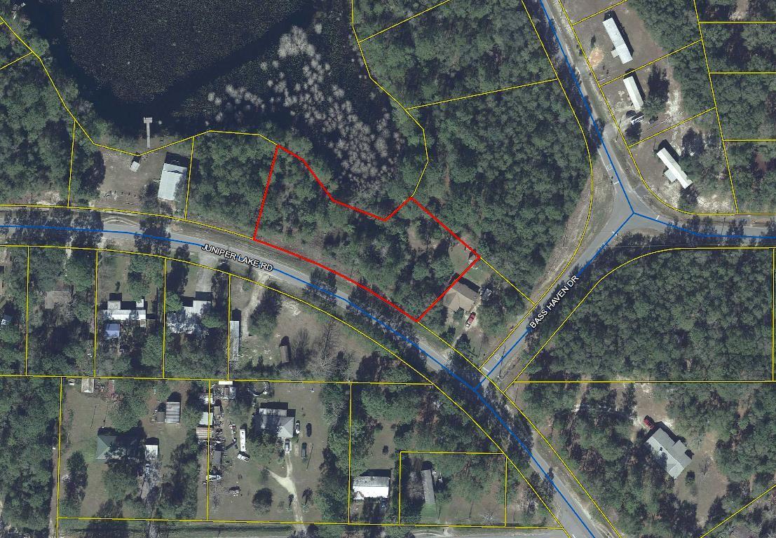 2 Beautiful lots totaling 0.76 of an acre, wooded lot located on Juniper Lake. Over 100'+ on the water according to property appraiser's site.. Lake Juniper is a state maintained lake. Water table has been drawn down by the state for repairs. All measurements subject to an up-to-date survey and elevation certificate.