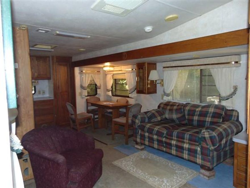 Great opportunity for an affordable getaway in Defuniak Springs. Located on paved road apx. 45 minutes from the beaches of South Walton County. Unique residence is a '94 New Wave 5th wheel joined to a converted 10x20 storage building, which is insulated and includes laundry room. Cozy, comfortable little place on a nice lot only minutes to town. Partial lot fenced for pets. Electric run to home; New septic and field lines in 2010; Water was previously shared from family member next door, but will need to pay tap fee and connect to public water (City of Defuniak quoted $1,969 to connect). Also built in radio & speakers for living and bedroom. Schedule your showing today!