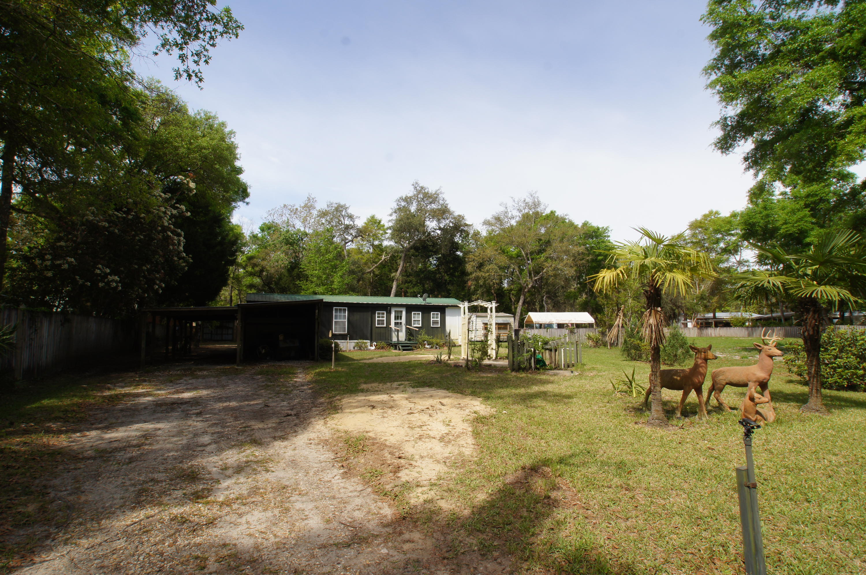 This is a two bedroom one bath, well maintained manufactured home located on a large lot in Freeport. Features include laminate wood flooring in the living/dining area, wood paneled walls, large laundry area, three storage sheds, a covered area to store a small boat and a covered area for lawn equipment. An enclosed den has been added on for extra living space which gives the home an additional 280 square feet making this home a total of 924 square feet. An expansive yard with mature trees makes this a quant little spot to call home. Choctawhatchee Bay and the Beaches of South Walton are both just a short drive away! Property being sold AS IS.