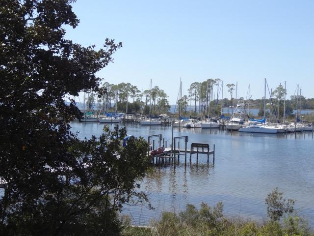 A Very rare find .. A deep waterfront protected lot with a Unique custom built Waterfront Home. This one owner home has incredible views over the cove towards Destin .. Steady breezes and beautiful trees makes this the ideal setting.High Ceilings throughout .. wood ceiling in Great Room .. Stone Fireplace .. Tile Floors .. open Floor plan with lots of open space. Large Price Reduction !!