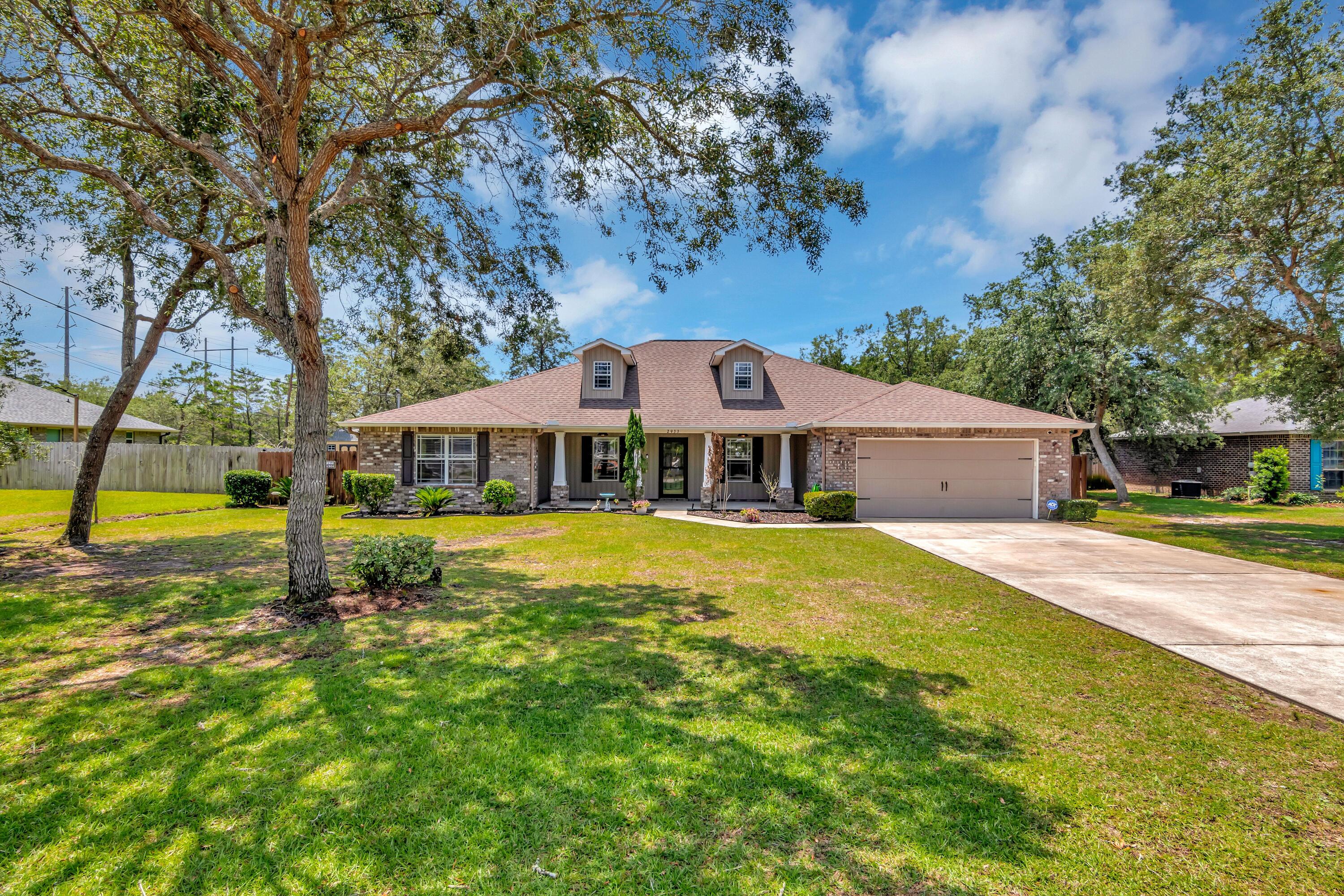 Sellers offering $10,000 contribution to assist with your closing costs or rate buydown! Welcome to this stunning all-brick home featuring an expansive front porch with four tapered columns and twin dormer windows! Spanning 2,076 square feet, this home offers four bedrooms, two full baths, and a versatile office space with double French doors. The formal dining room and an impressive 20 x 16 family room with a vaulted ceiling are perfect for entertaining. The family room, foyer, office, and formal dining room boast light wood like designer tile, while all bedrooms are comfortably carpeted. The kitchen is a chef's delight with staggered premium dark wood cabinets, a large island topped with double top butcher block, beverage fridge, pot rack and ample storage.