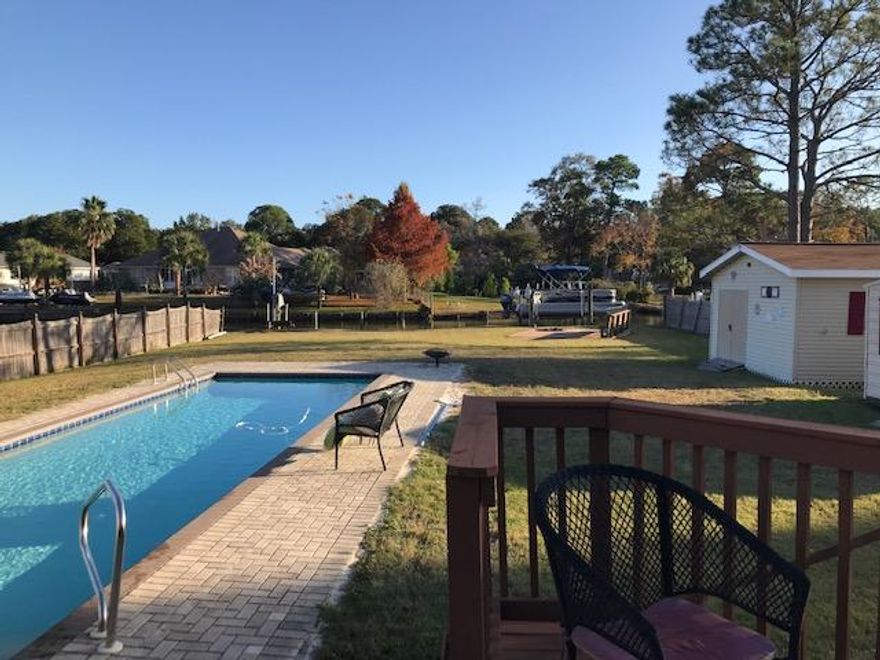 Waterfront Updated Pool Home on .47 acre lot in FWB! Located on Protected Water that opens to Choctawhatchee Bay! 84ft Waterfront! Walk to the Fort Walton Beach Yacht Club, Ferry Park & Uptown Station! Fantastic location with the best neighbors ever! 4 Bedrooms, 2 Full Baths - Both baths have New Granite Double Sink/Vanities & New Faucets. The Split- Bedroom Floor-plan is Open so you can view Living Room & Back Yard from your Kitchen. Solid Cherry Cabinets in the kitchen, with an additional 12ft+ wall of the same Cabinets in Laundry/Utility room next to kitchen. Two of the 36'' Cabinets are extra deep with designer pull outs. Two others have stacked pull out drawers. Upper cabinets are deep and wide - Amazing Kitchen Storage!