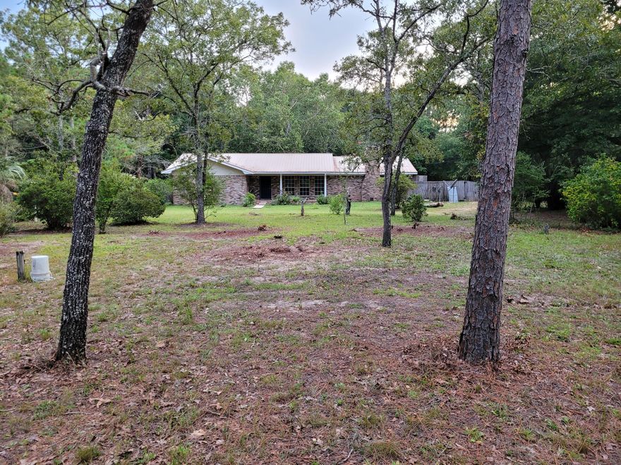 Enjoy the privacy!  Completely remodled and upgraded interior about 2 years ago.  Features a great room with a wood-burning fireplace.  Kitchen with extra generous cabinet storage, deluxe laundry room, and spacious bedrooms.  Huge backyard is completely privacy fenced.  Also boasts a screened back porch and additional patio.  Situated on a 3+ ace property loaded with flowering shrubs and mature trees. Five minutes from Crestview High School & Davidson Middle School.  $2200 per month, with a $2200 security deposit due upon signing. Owner is a licensed Florida and Mississippi Real Estate Agent.