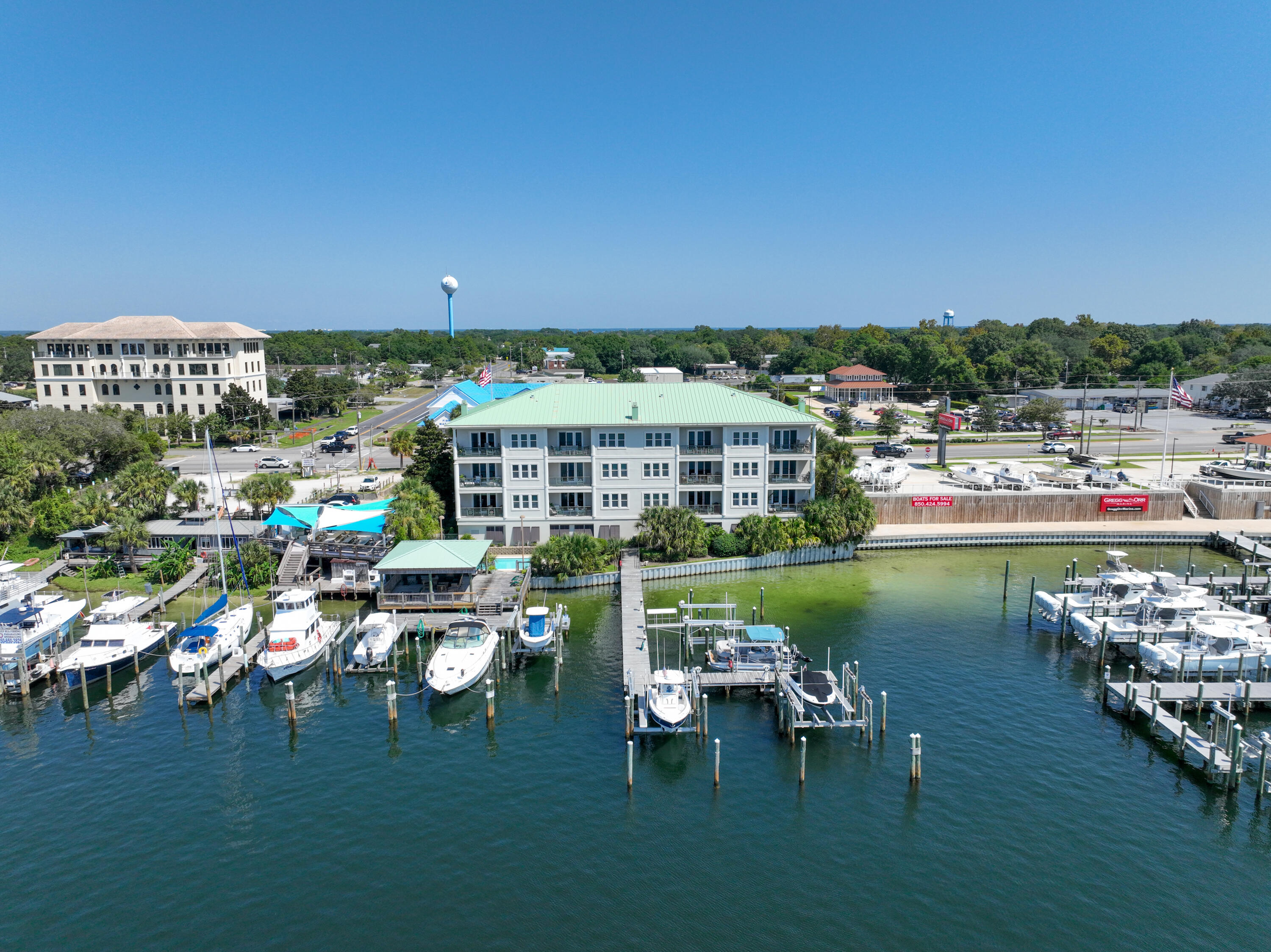 Discover coastal elegance in this stunning harbor-front condo offering an unmatched blend of comfort, convenience, and breathtaking views. Perfectly positioned in the heart of Destin, this non-rental property is your private oasis, delivering panoramic sunsets and fireworks from your very own balcony. Step inside to find plantation shutters throughout and blackout shades that create a serene, stylish environment. The open-concept living area is ideal for entertaining, featuring a sleek wet bar, perfect for evening cocktails or hosting guests. This condo boasts high-end updates, including a 2-year-old A/C system, a new washer, dryer and an O3 Pure Professional Ozone Eco Laundry Washer System and a Stielbel Eltron tankless water heater for endless hot water on demand. Smart living is at your fingertips with an EcoBee smart thermostat and a Ring camera and alarm system, giving you comfort and security wherever you are. Convenient water transportation is available to harbor front restaurants aboard the Destin Water Taxi. This residence also includes: Private boat slip (Boat Slip C) with a 3-year-old lift, Owner's closet in garage for secure personal storage, two parking spaces and presenting 10ft ceilings throughout the unit. Whether you're unwinding on the balcony or heading out for an evening cruise from your private slip, this harbor-front gem offers the best of coastal living with all the right upgrades. Schedule your private showing today and experience the sunset views and unbeatable location for yourself. See list of items that do not convey in document section.
