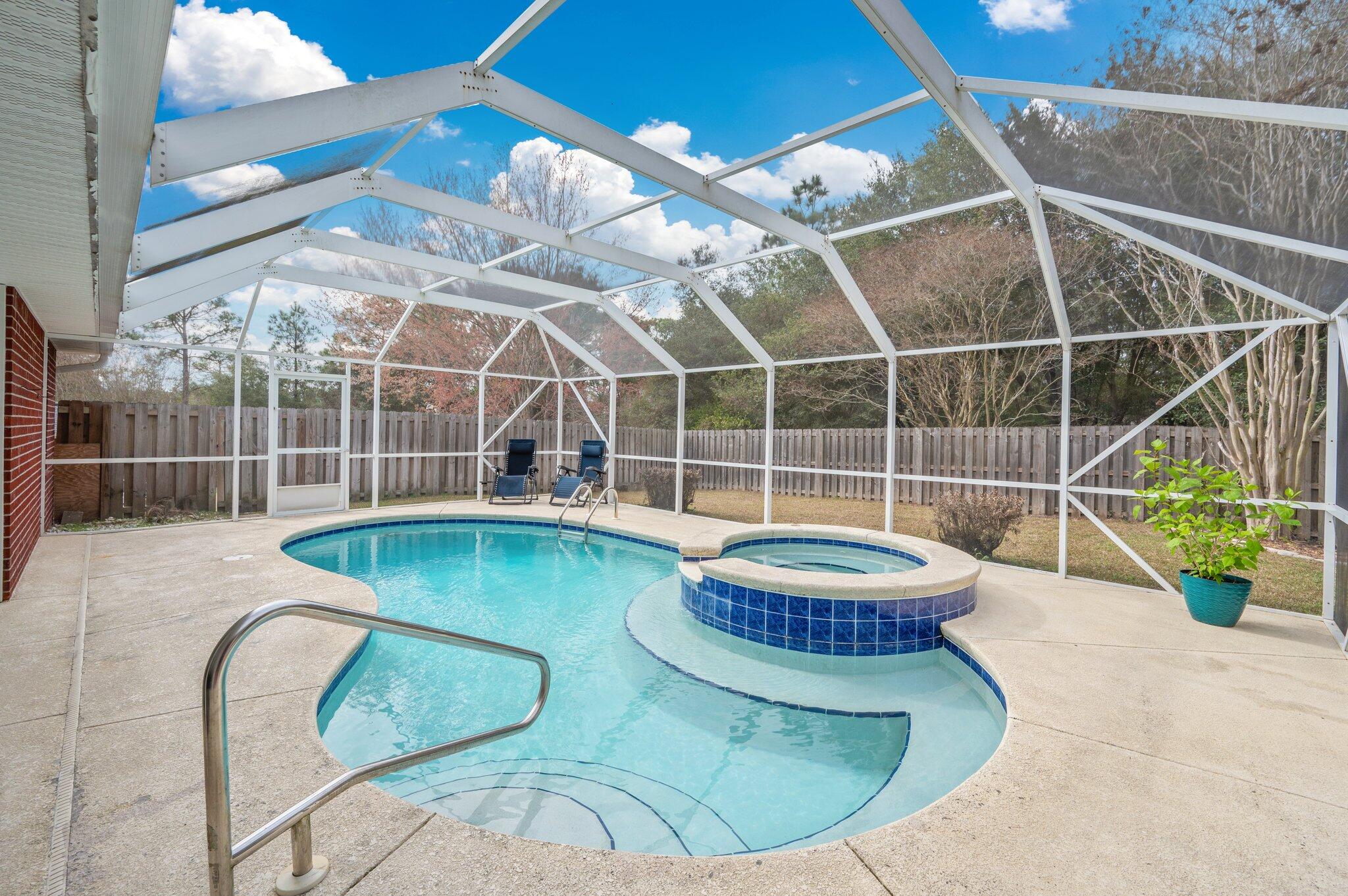 Beautifully Maintained South Crestview Home with Saltwater Pool & Hot Tub!This impeccably maintained 4-bedroom, 2-bathroom home in South Crestview is ready for its next owner! Featuring a stunning in-ground saltwater pool and hot tub with remote-controlled lighting, a waterfall feature, and a screened enclosure to keep the bugs and leaves at bay. This backyard is built for relaxation and entertaining. Inside, you'll find stainless steel gas appliances, Smart Core flooring throughout, , and water-softening shower fixtures. The privacy-fenced backyard backs up to a serene preserve--no rear neighbors here! Major system updates include a brand new water heater (2025), a dimensional shingle roof (2020), and an HVAC system (2019).