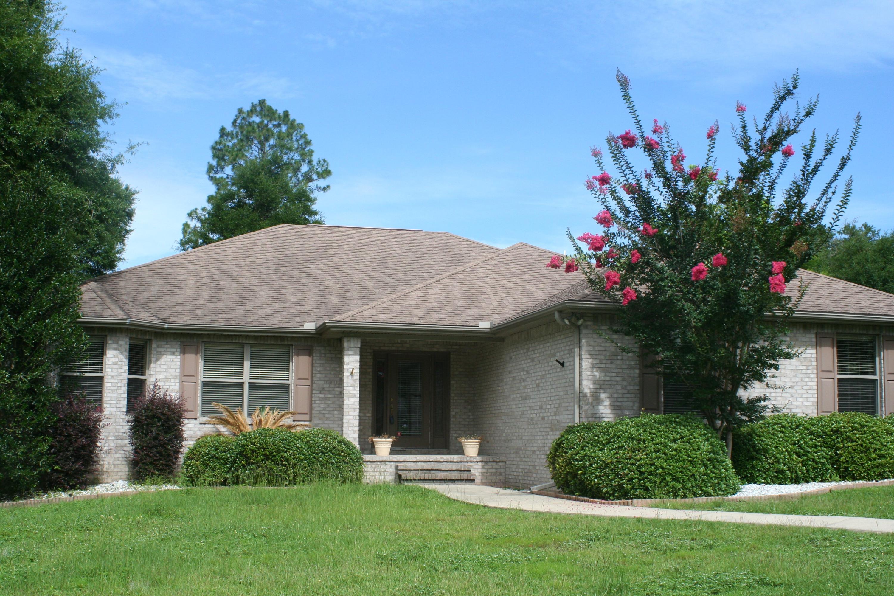 Seller says Bring All Offers!! This 4 bedroom 2 bath brick home offers an open split floor plan with 18'' tile laid diagonally, raised ceilings, crown molding, 6'' base boards, a beautiful built in entertainment center opening onto the large deck, perfect for entertaining! The kitchen offers a nice raised breakfast bar with eat in dining featuring trey ceiling and stainless steel appliances. The master suite features a whirlpool tub and separate shower with two walk in closets and two vanities. You will find this home nestled on a fenced corner lot surrounded by trees driving into the quiet cul de sac. See it today!