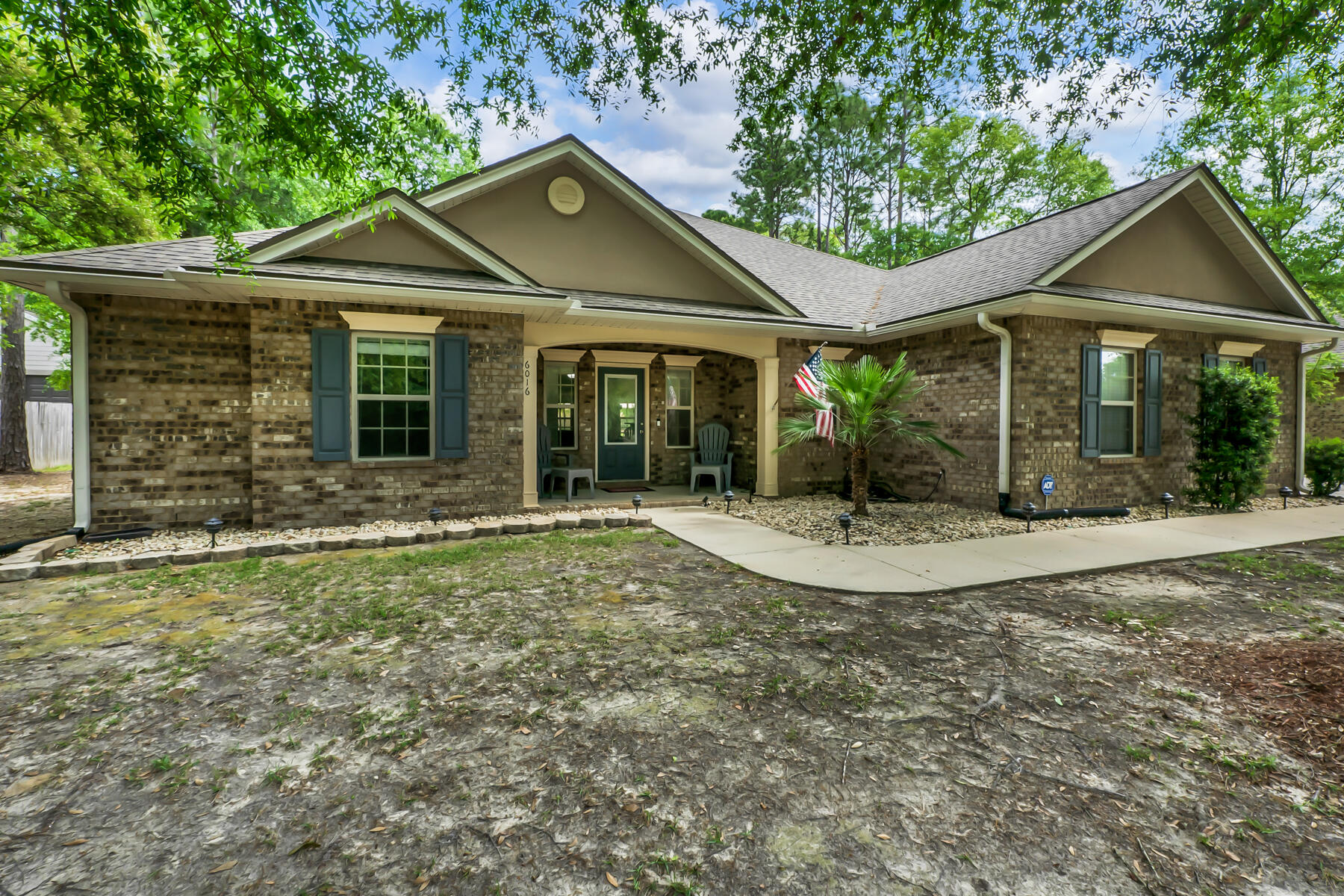 Welcome to your new home in Camellia Cove! This charming all-brick residence offers the perfect blend of comfort and space. Situated on a generous half-acre, with covered front and back porches and a large, privacy-fenced back yard, you'll have plenty of room to bring your creative visions to life -- enjoy the luxury of space and privacy in this peaceful setting.Inside, you'll find a spacious single-story layout featuring a large open great room, perfect for gatherings and relaxation, complete with built-in bookshelves. The roomy, eat-in kitchen is a chef's delight and features granite countertops, plenty of counter space, stainless appliances (including a flat cooktop stove), and a pantry. The split bedrooms offer privacy and tranquility,. The primary bedroom has its own en suite