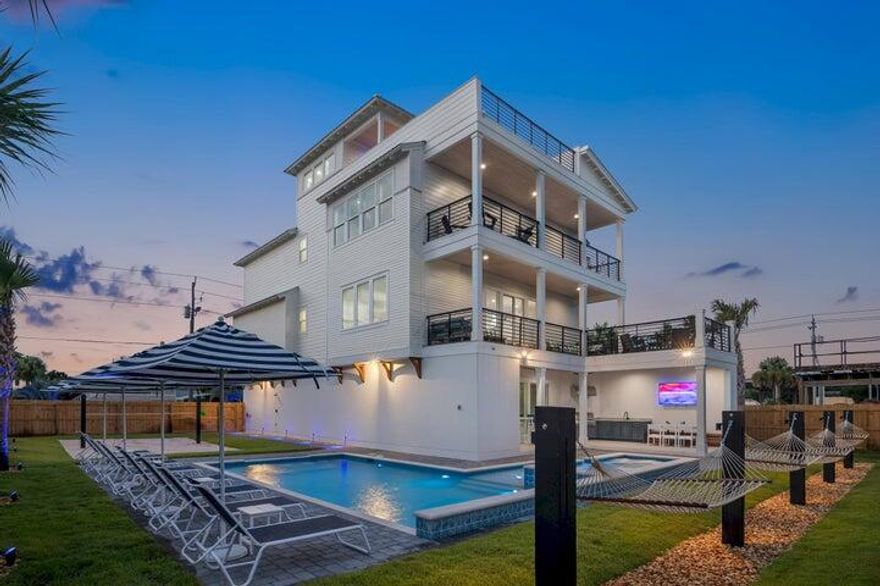Welcome to Casa Blanca, a newly constructed Gulf Coast playground designed to stand out from other vacation rental homes. The first level is designed to resemble a social hotel lobby offering a flashy wet bar, pool table, multiple Smart TVs with Sonos Surround Sound, a photogenic plant wall of assorted foliage, and a custom glass ping-pong table created by local artist Blake Miller. Floor-to-ceiling windows lead you to the outdoor extended patio, where the summer kitchen is tucked away and features a marine-grade steel grill. A large outdoor TV is connected to another Sonos Surround Sound System, allowing the entertainment to continue outdoors. Another differentiating quality is the available sitting options around the pool: poolside hammocks, chaise loungers with matching umbrellas, a bar top, and a built-in 6-seater dining table allow guests to lounge around the pool any way they wish.

The pool features two sheer descent waterfalls, a massive 14+ person hot tub, a tanning ledge, and a walk-up bar overlooking the beach volleyball court. All of this is concluded with landscaping lighting offering an alluring atmosphere all night.

The second level of Casa Blanca is designed with an elevated classic coastal approach, featuring lush white cloud couches, driftwood coffee tables, and engaging artwork. The noteworthy kitchen offers a professional 48" Viking gas range with double oven, two dishwashers, and an impressive kitchen island. It's a "Turn-key" kitchen, fully equipped for guests to easily prepare large meals.

On the third level, you will discover the "Havana Lounge," a moody common space defined by its edgy coffee bar and lounge area. It showcases ritzy wallpaper with complementing board-batten walls.

The fourth and final level boasts the rooftop bar, which has a substantial twelve-foot island with a prep sink, ice bin, and smart TV. Even more impressive is the fire pit, which is plumbed with natural gas and has an electronic ignition setup.

Another notable quality is that the residence is only 1,500 feet from the Gernomino Public Beach, one of the newest and largest public beach accesses on Scenic 98.

The developers of Casa Blanca have been operating luxury vacation homes on the Emerald Coast for the last ten years, creating properties that outperform the industry average. This is not just another home for sale but a carefully curated income-producing property with more features, allowing for better algorithm positioning on all online platforms, such as VRBO, Airbnb, ECBO, Direct Booking sites, and much more. Whether you place Casa Blanca on your favorite rental program, manage yourself, or keep it in the existing program (which has its benefits), Casa Blanca is sure to become a staple in the vacation rental industry for years to come. 