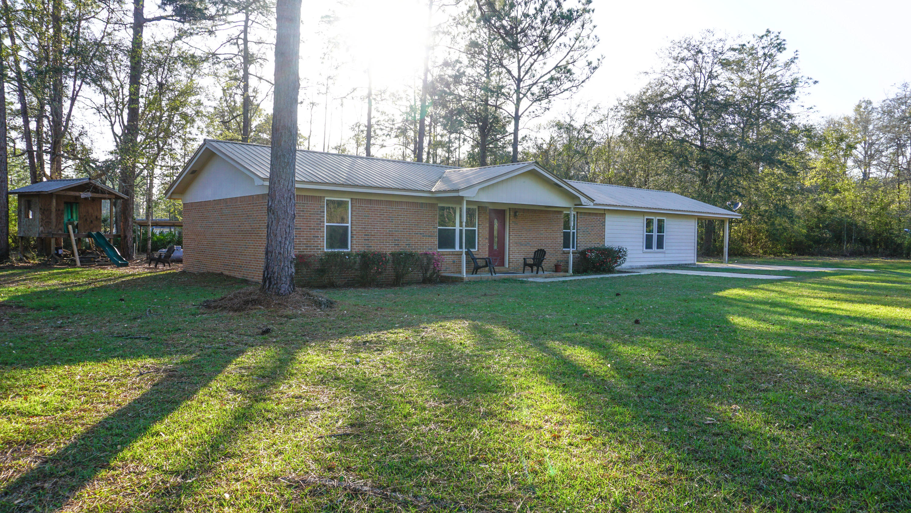 Completely renovated home on a large lot. Home boasts 3 bedrooms and two bathrooms with a split floorplan. As you enter this home you will feel the warmth and charm of home. The living area features all tile plank flooring, built in shelving and large windows to provide ample natural light. As you enter through the dining room you enter a galley style kitchen with new stainless steel appliances, counters and cabinets. The beautiful fixtures and fans are sure to please. Off the dining area is a bedroom and full bathroom. To the other side of the house a large master bedroom and enormous master closet, guest bedroom, bathroom and laundry. Behind the house a tree house and covered parking area.