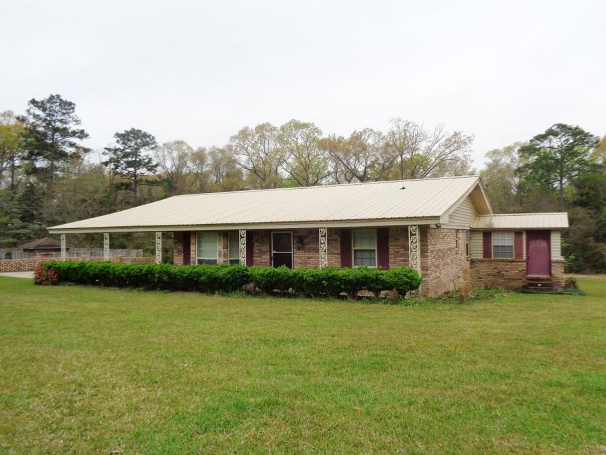 Welcome to your your new country home! With an easy commute to Crestview and Duke Field, you'll find this sturdy, well-kept, affordable brick home on 4.7 acres, complete with a metal roof and an in-ground pool. This home features a formal living room, dining room, and family room, complete with a wood burning heater. Updated kitchen with added cabinetry. Bonus room off of the family room could be used as an office or mud room. Laundry and storage is just off of the carport. Outside you will find a yard building and workshop. Beautiful azaleas scattered throughout the property! Relax out front on your gorgeous covered porch! Plenty of space and tons of potential! Seller is offering $5000 towards upgrades...update the paneling and replace the flooring to your liking!