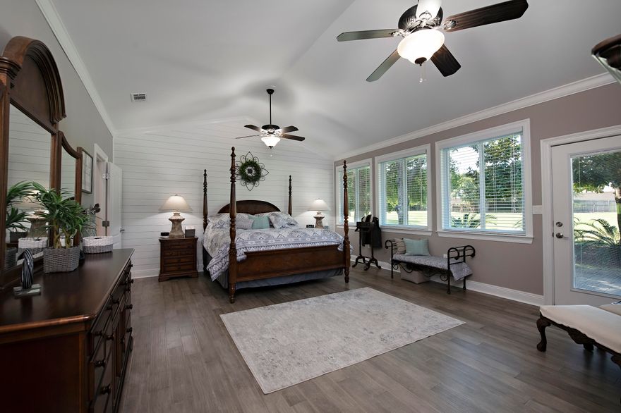 the entire home has 9 foot or volume ceilings and extensive crown molding and chair rail. There is ceramic tile flooring in most areas and engineered hardwood in the master. The lodge style great room features a tongue and grooved wooden ceiling and fireplace with gas logs. The master bedroom has new paint, hardwood flooring, a shiplap feature wall and new blinds. Windows were replaced with Andersen Low-E ones that let natural light in, assist in lowered electric bills, and also help stop fading of fabrics and woods that can occur with regular glass. The kitchen has 42'' custom cabinets with tons of storage, quartz countertops, tiled backsplash, stainless steel appliances, center island with cooktop, downdraft vent, and overheard lighted pot rack. Ge Monogram Standalone ice maker. Two pavered driveways, 3 car garage, intercom system, large rear patio, and many windows to see the beautiful landscaping and golf course. Walk in closets in all bedrooms, ten ceiling fans.  2 hot water heaters, 2 heat pumps that divide the home in 2 zones for accurate heating and cooling.  Tucked away in a quiet neighborhood from most of the resort, yet just a short golf cart ride to Baytowne Village & Marina, the beach, 4 golf courses, New Vision Theater, Publix, the bay, fitness centers, resort pools and dining & shopping at Grand Boulevard.  This home must be seen to be appreciated.