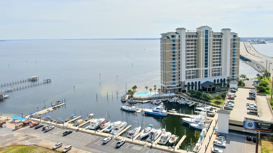 Experience waterfront living at Marina Landing with this 2-bedroom, 2-bath high-rise condo offering 1,384 sq. ft. of comfortable coastal living. This 8th-floor unit showcases stunning panoramic views of St. Andrews Bay from every room and features an expansive balcony with a built-in grill--perfect for entertaining or relaxing at sunset. Both bedrooms are bayfront suites with balcony access and walk-in closets. The primary bathroom includes a double vanity, separate tiled shower, and soaking tub. The open-concept living and dining area is highlighted by floor-to-ceiling windows that fill the space with natural light. Marina Landing offers resort-style amenities including a bayfront pool and spa, fitness center, picnic area, and boat launch access. One assigned covered parking space is included. This community does not allow short-term rentals, providing a serene and private atmosphere for full-time residents or second-home owners. All information is deemed accurate but should be verified by the buyer and/or buyer's agent if important. Schedule your private showing today!